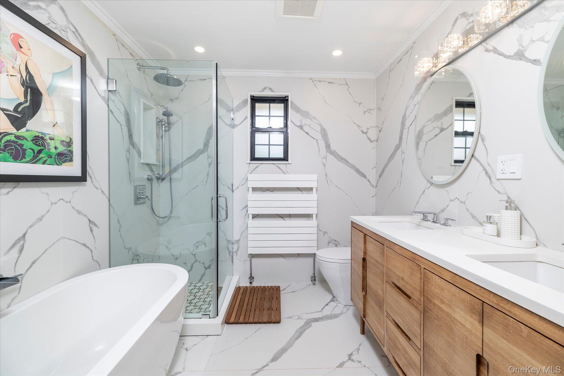 Bathroom with a freestanding tub and glass enclosed shower