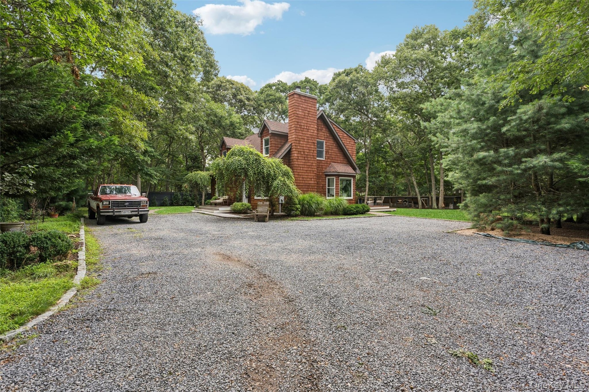Wood-shingle exterior featuring a prominent chimney and bay window