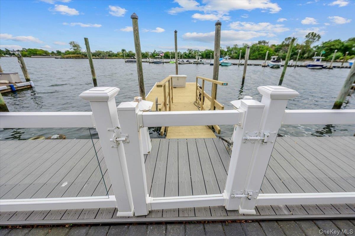 Deck w/ clear fence and new dock. Space for 2 boats