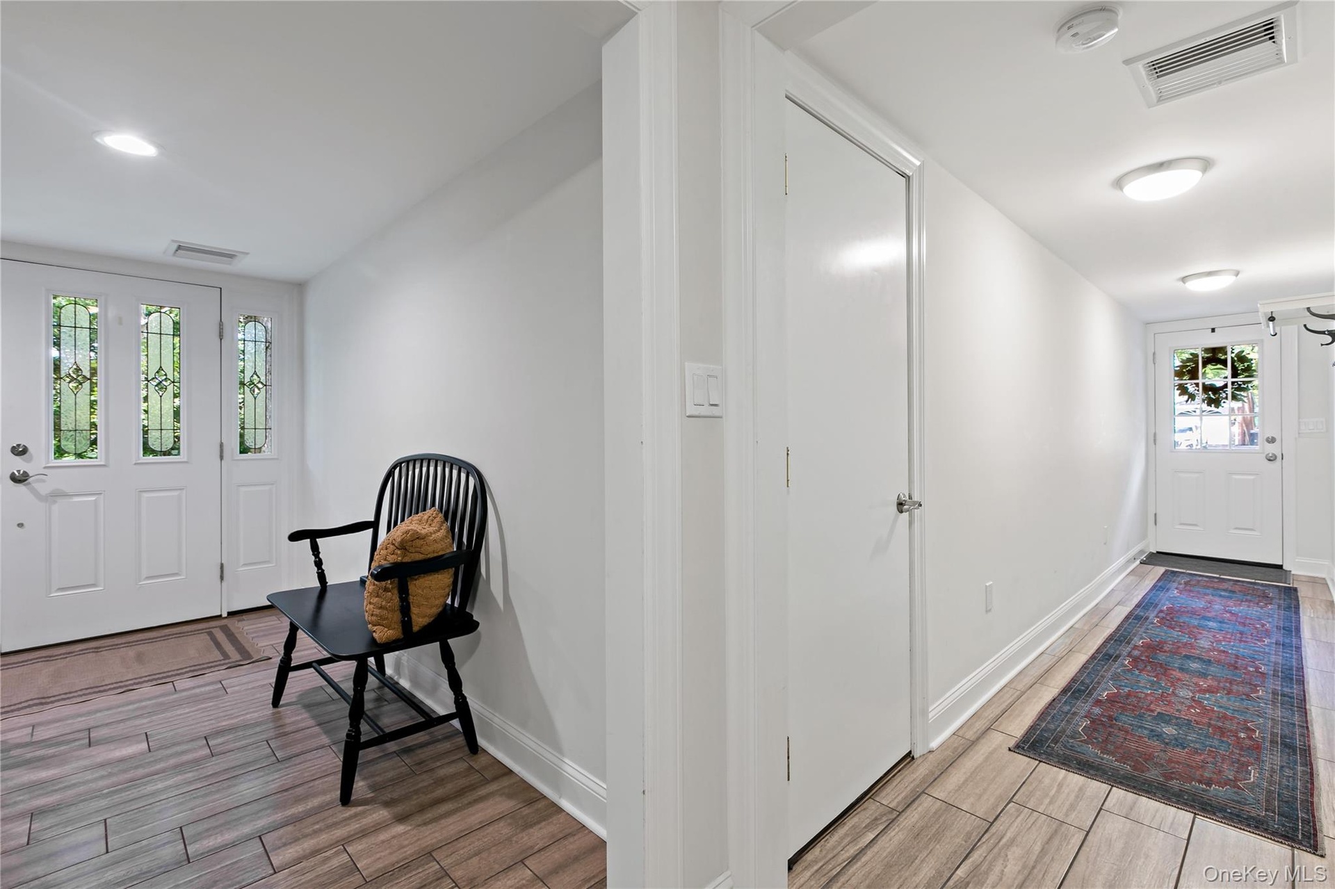 View of front and side entrance with foyer and hall