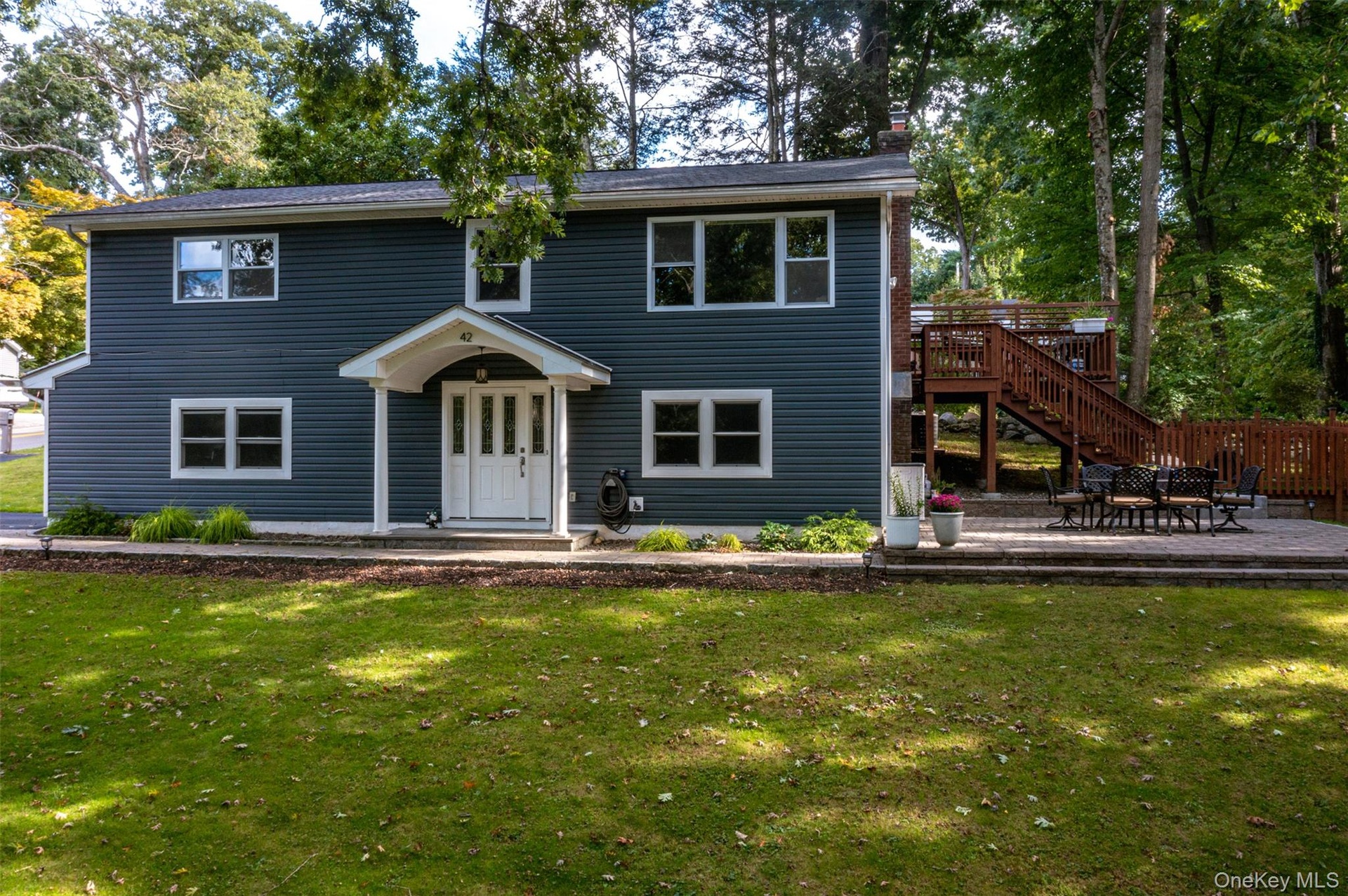 Front exterior of house and side deck and patio