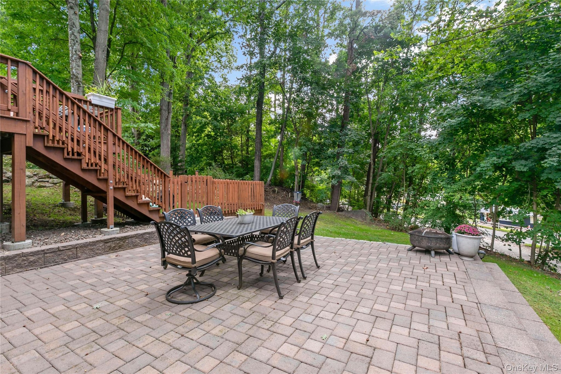 Stone Patio with stairs to Deck