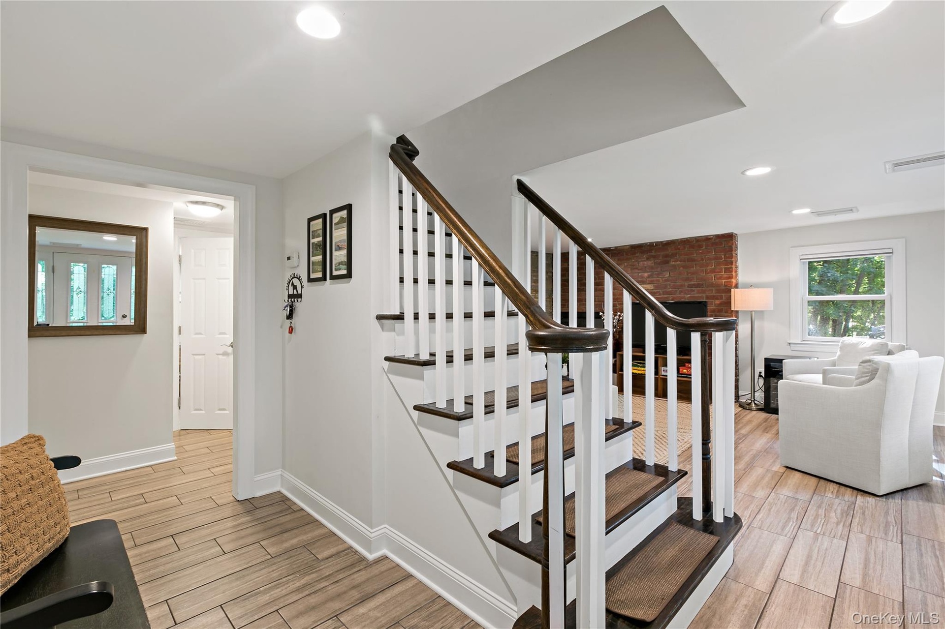 View of stairs to upper living level and Family Room in background