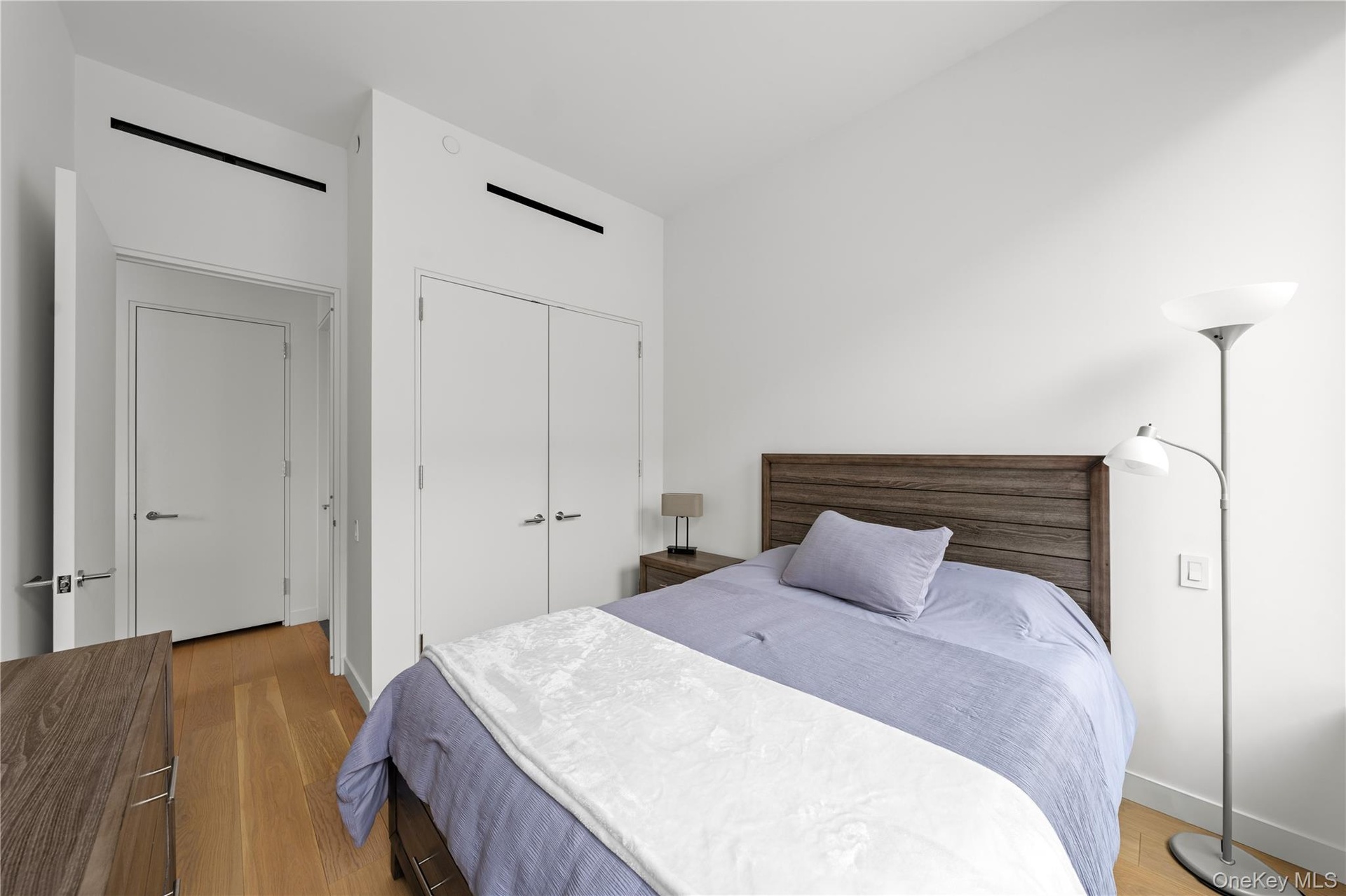 Bedroom with light wood-style flooring and a closet