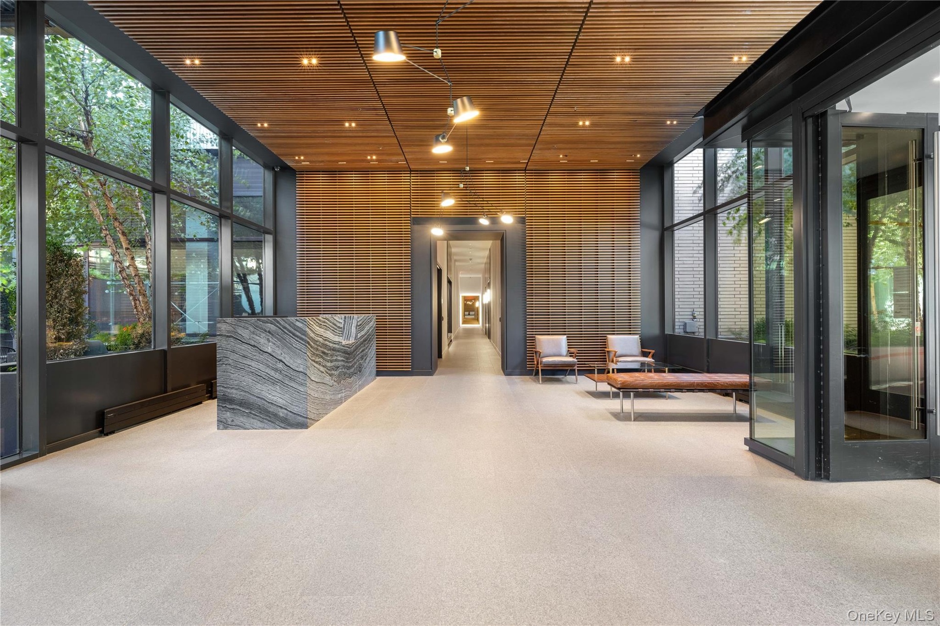 Community lobby with floor to ceiling windows and wooden ceiling