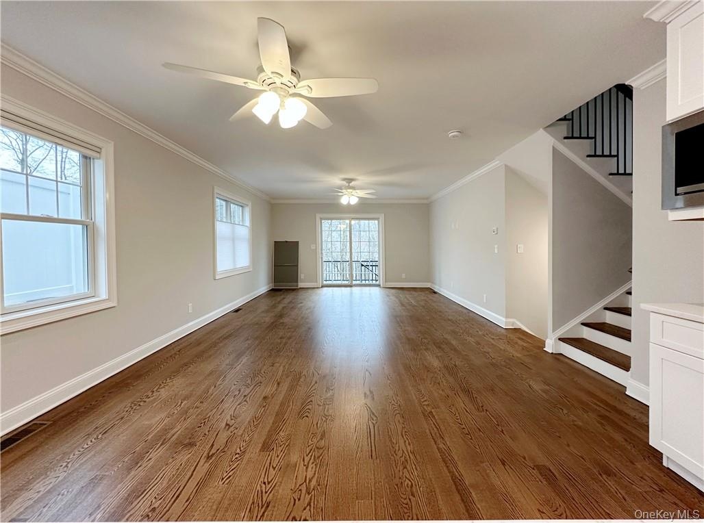 Open concept living space, living room with dining area in foreground.  Sliders to backyard.