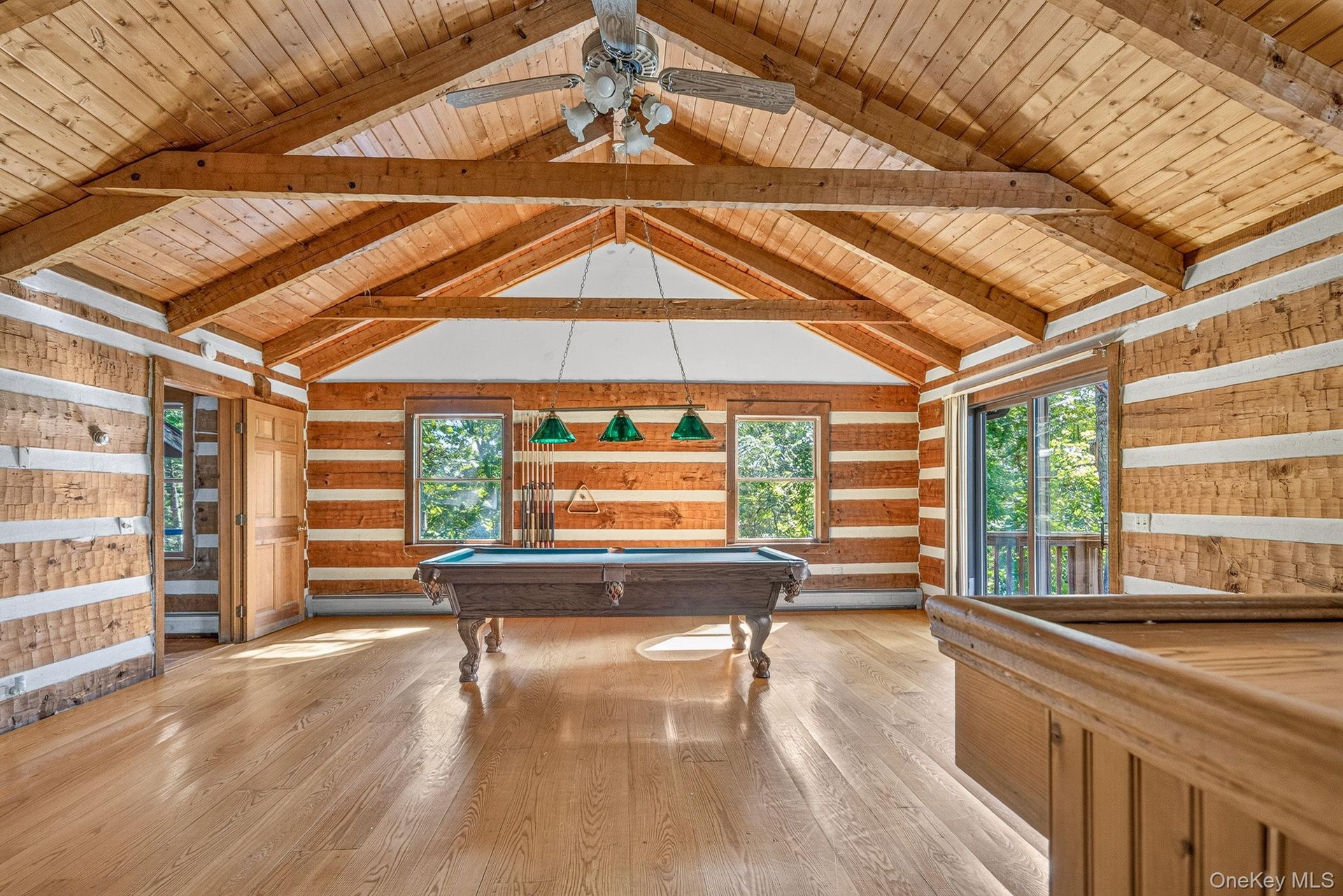 Vaulted beamed ceilings.  Wide plank hardwood flooring.