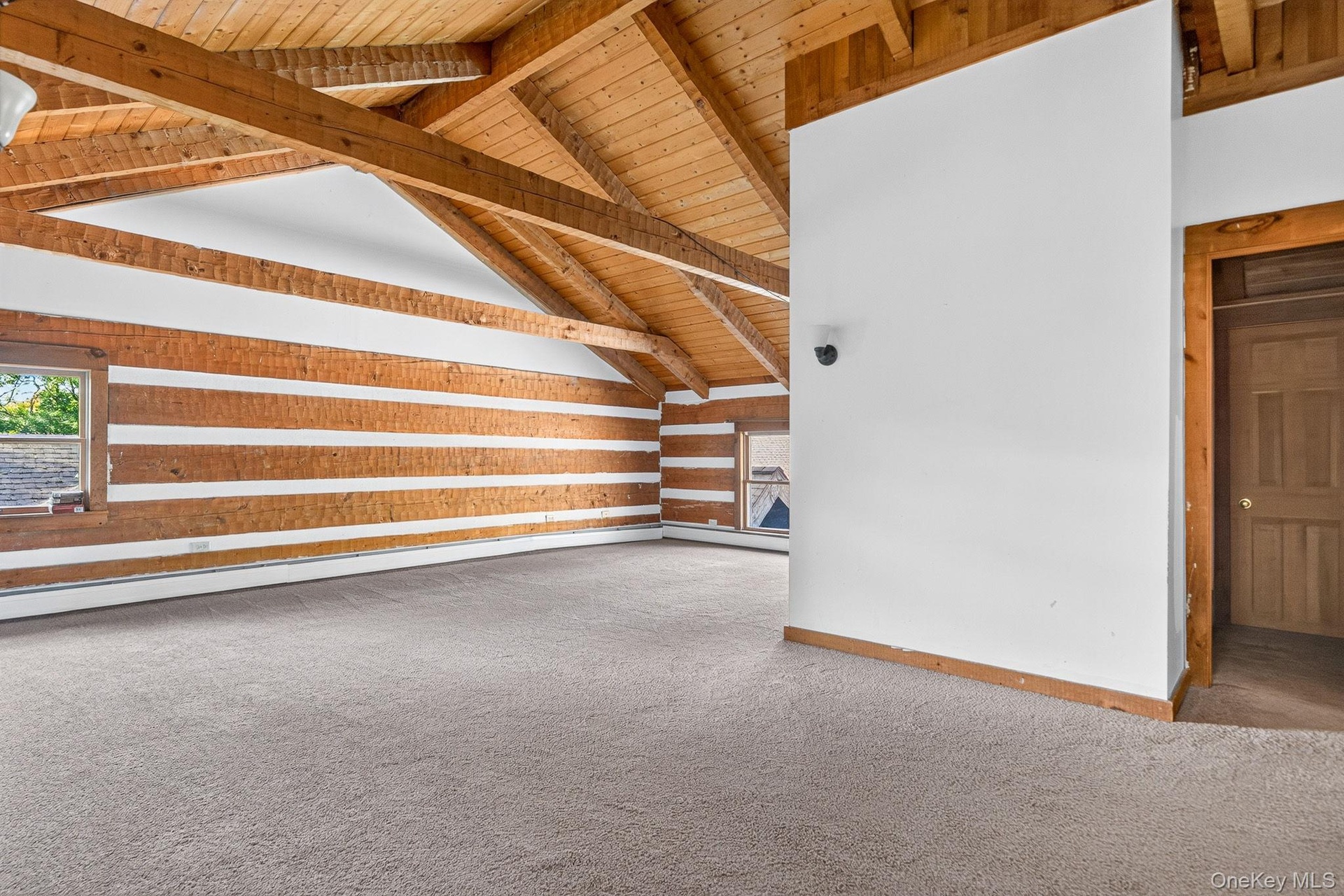 Main residence, second floor lounge area/bonus space.  Door leads to full bathroom.