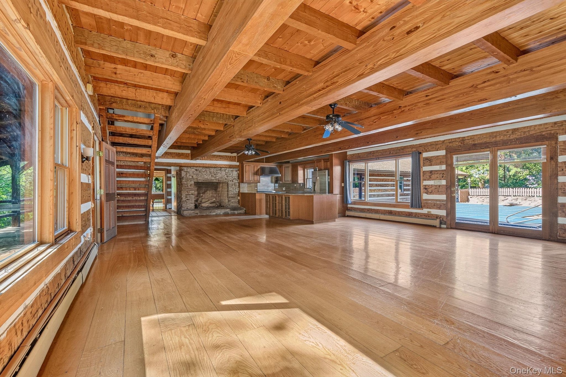 Open family room/dining area/kitchen.  Access to front porch and pool courtyard.