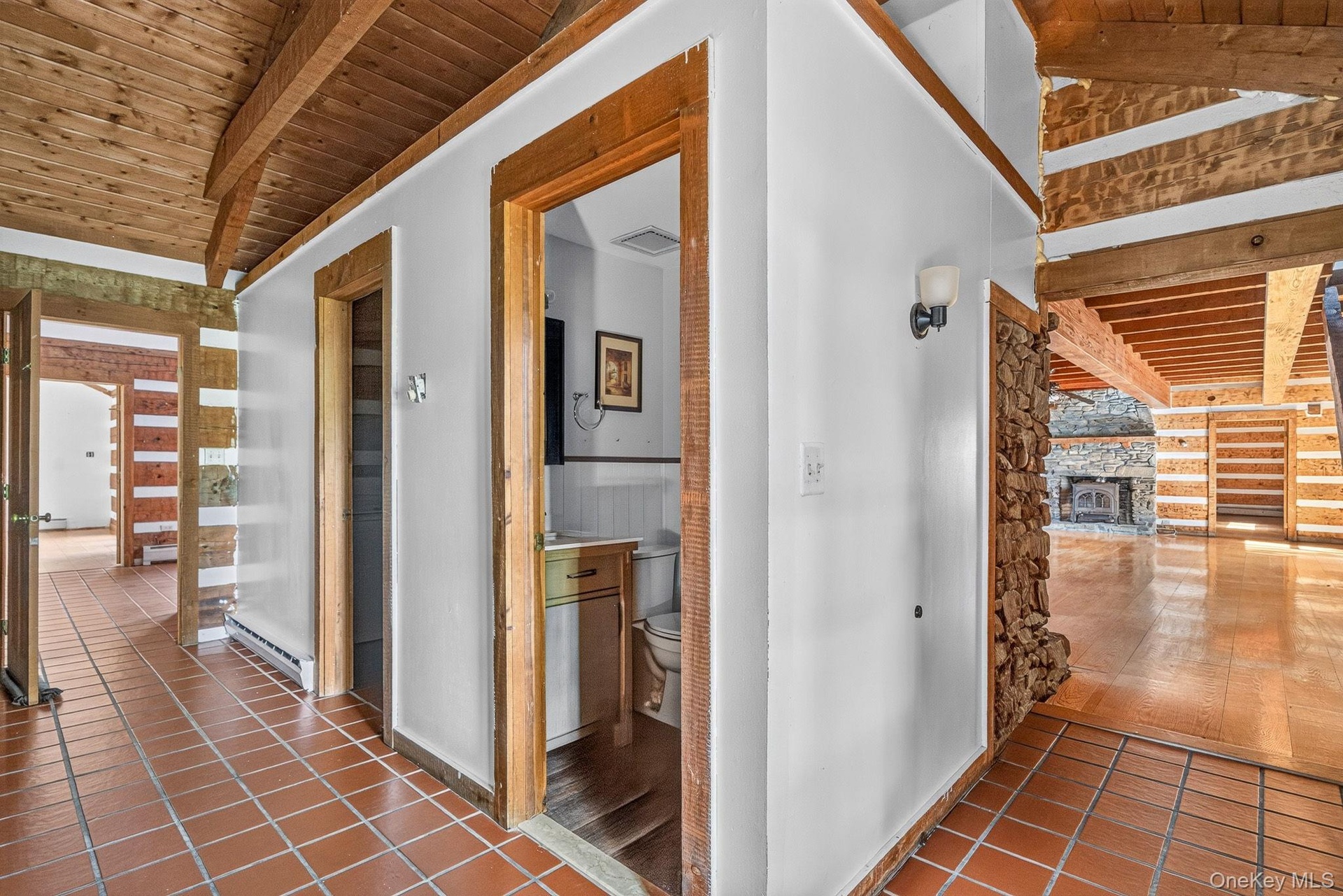 To the right leads to main residence.  Straight ahead is an updated half bathroom.  Adjacent is a laundry room.  Straight ahead leads to residence #2.