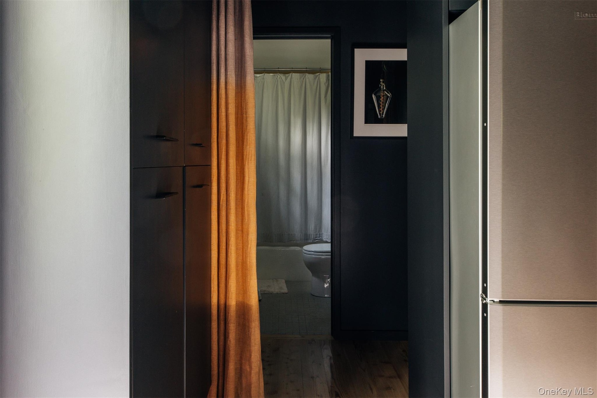 Corridor featuring wood finished floors