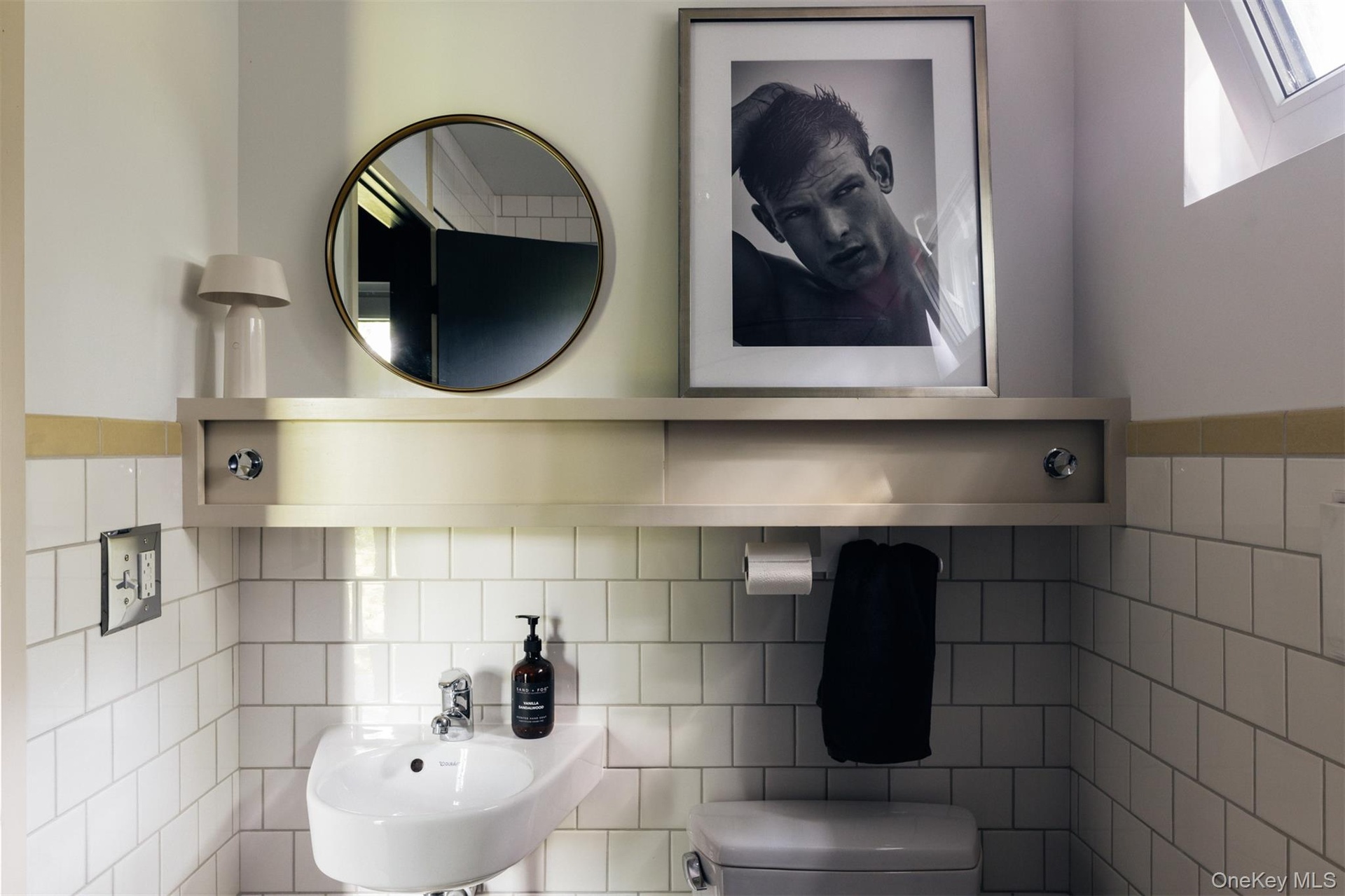 Half bathroom featuring tile walls