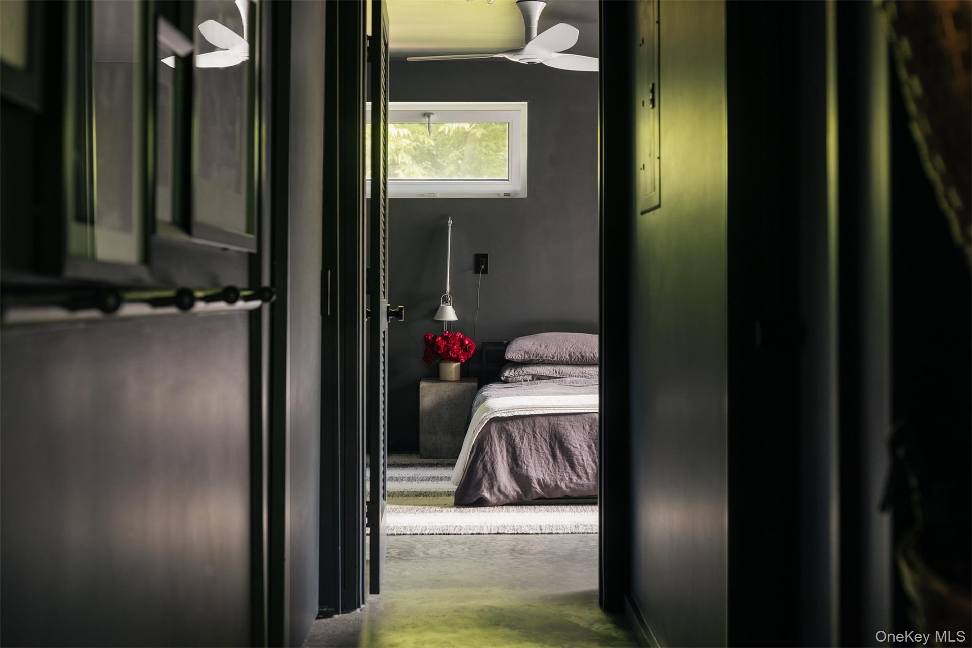 Bathroom featuring ceiling fan, ensuite bath, and concrete flooring