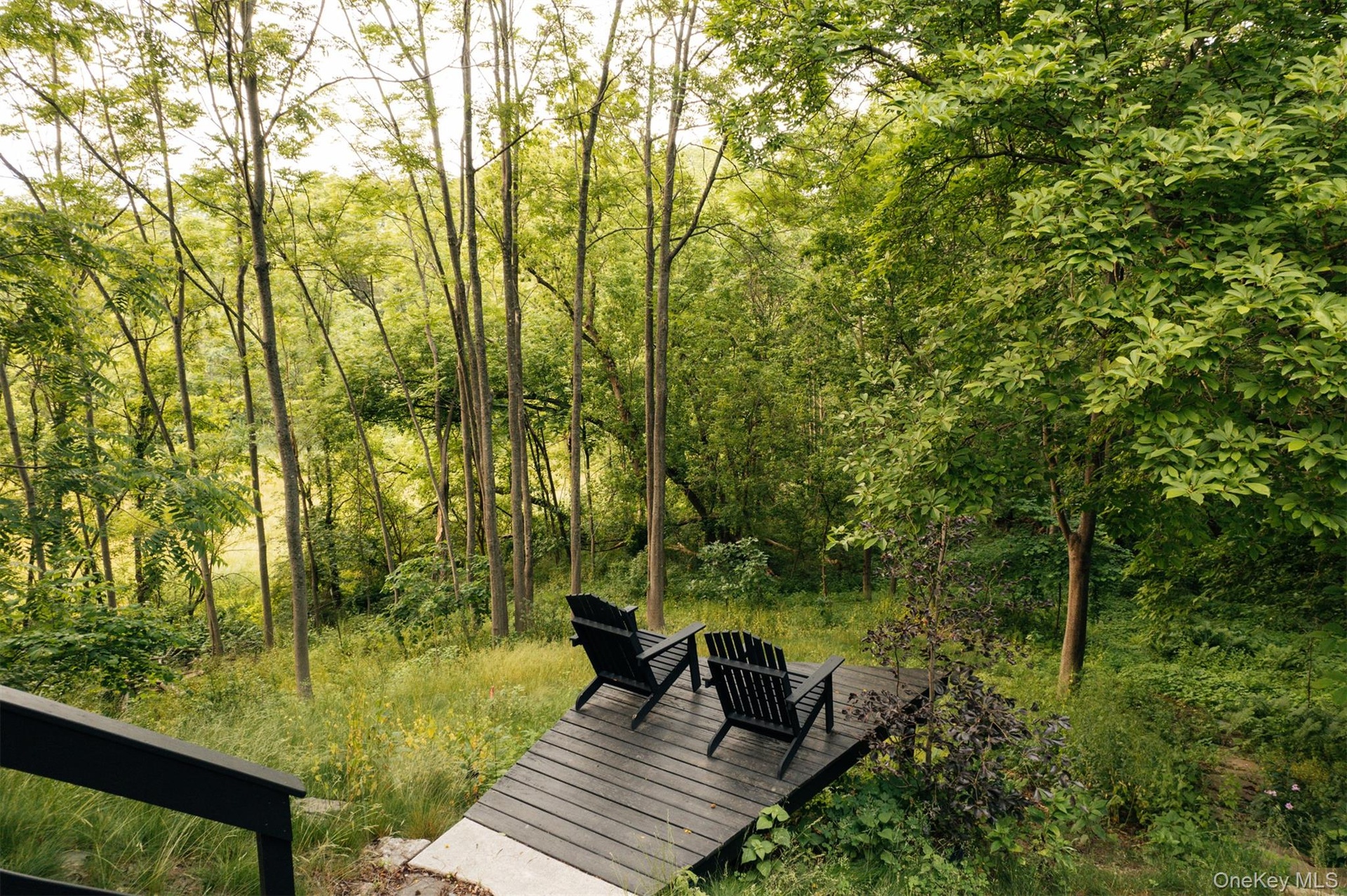 Surrounding community featuring a deck and a forest view