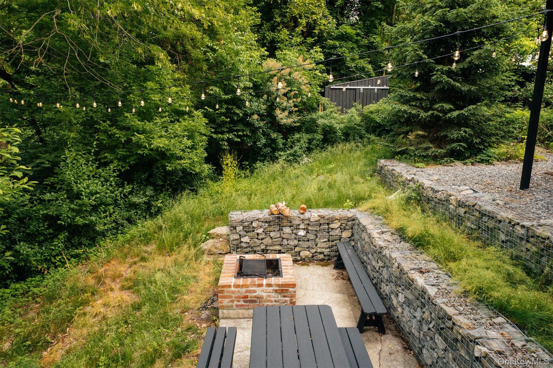View of yard with a fire pit and a patio