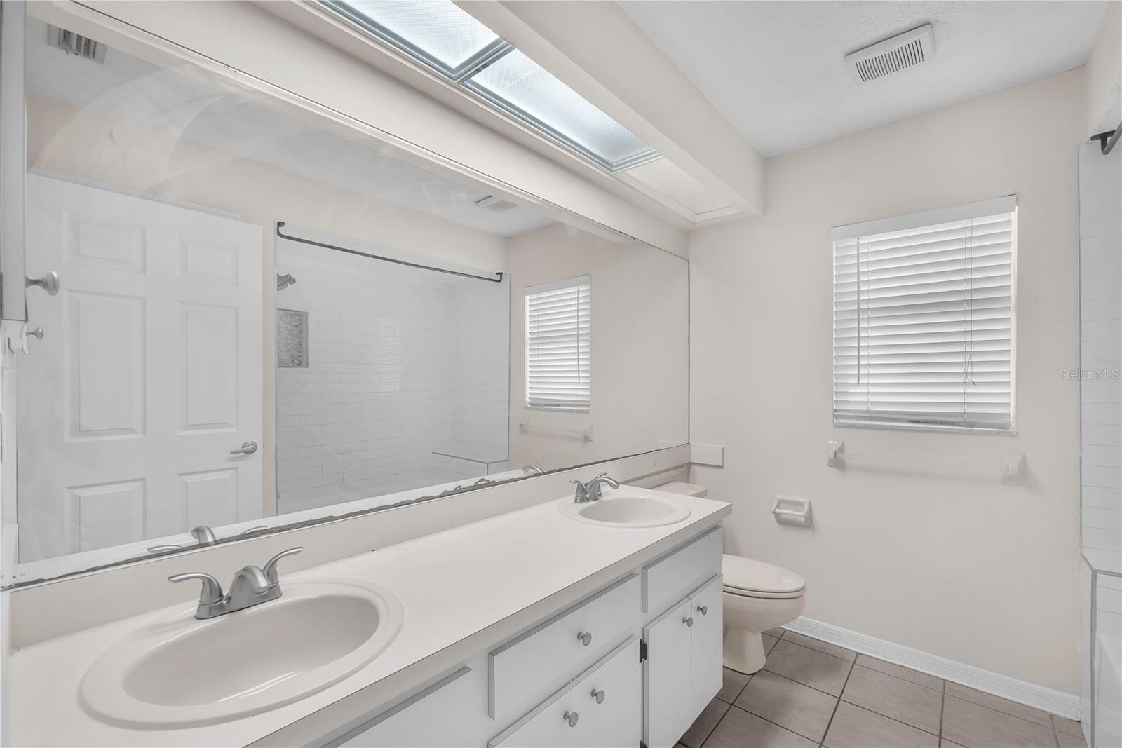 Full bathroom that is shared by the secondary bedrooms has dual sinks and a tub/shower combination.