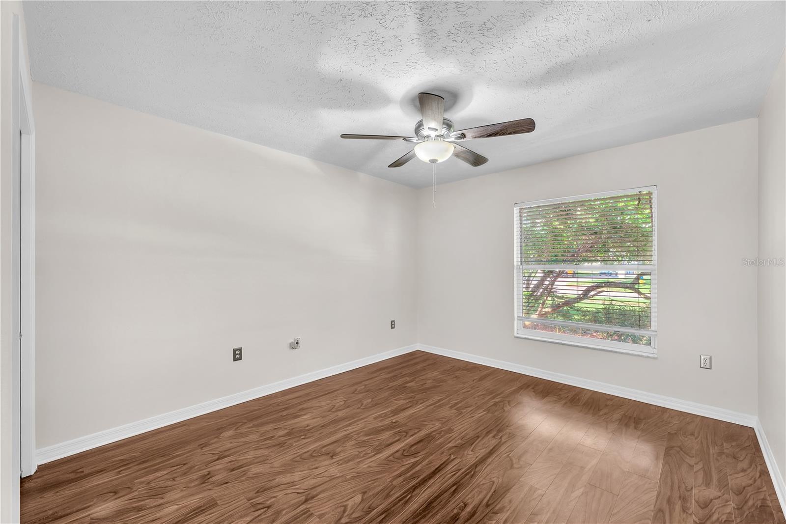 Bedroom #4 located to the right of the foyer has a built-in closet and would make a perfect office space with the double french door entry.