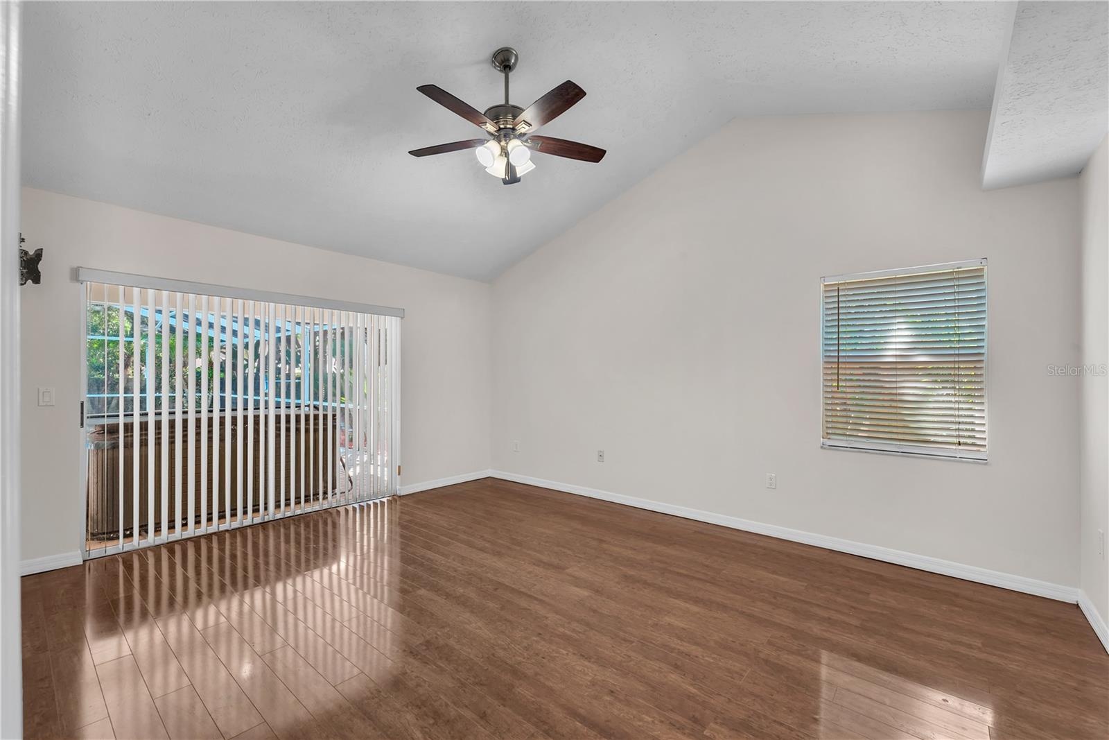 The spacious Primary Suite is tucked away on one side of the home and features two walk-in closets, Vaulted ceilings, private access to the screened l