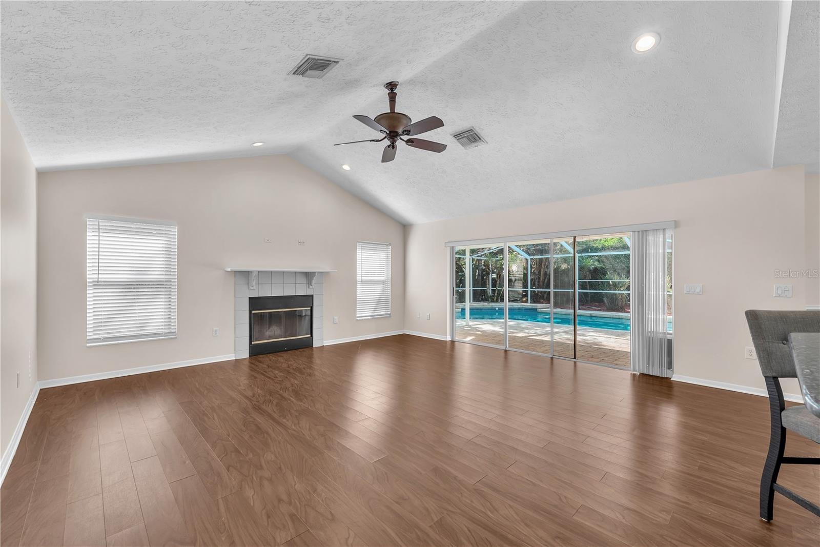 A triple sliding glass door in the family room opens directly to the pool lanai, creating a seamless connection between indoor and outdoor living.