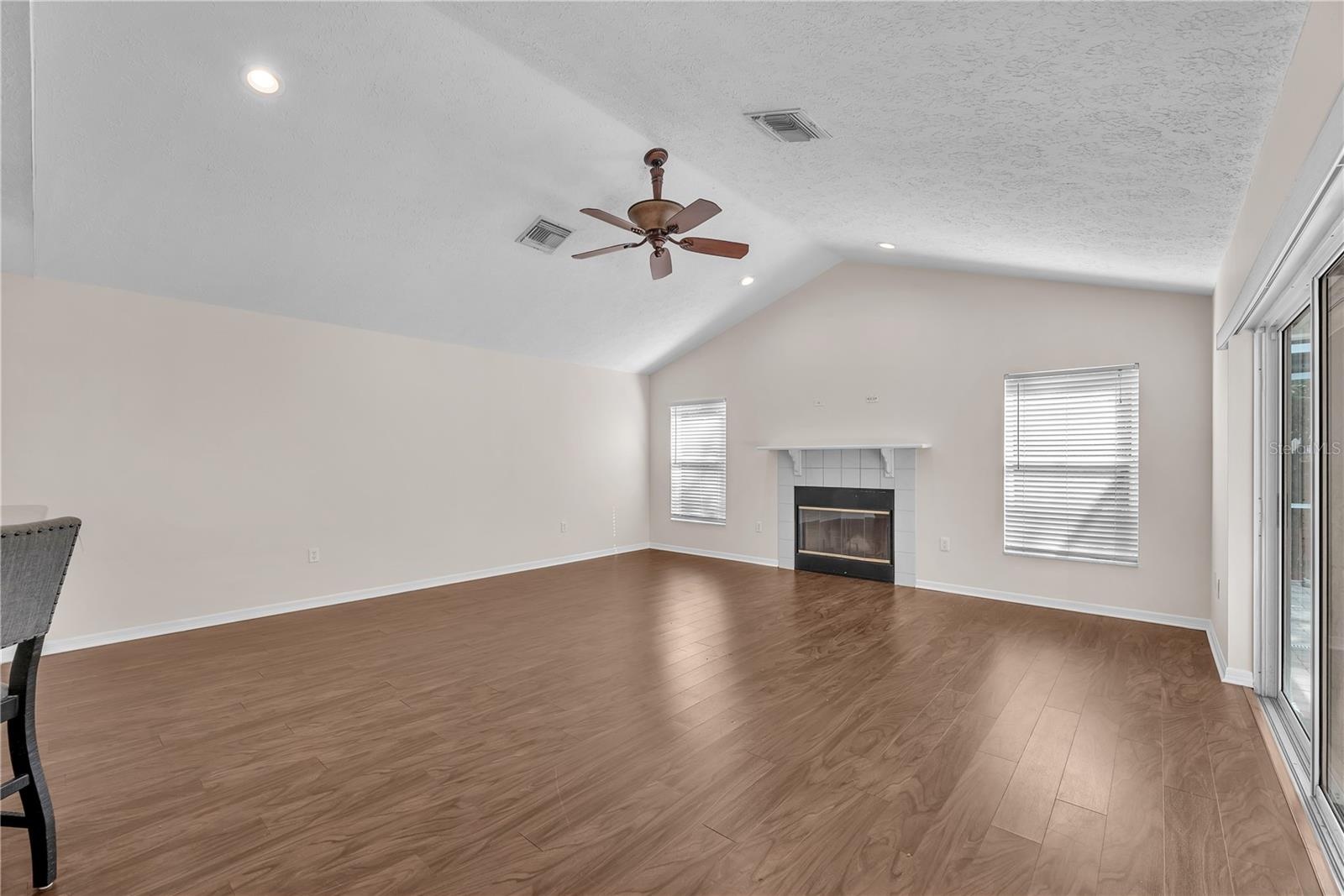 The inviting family room centers around a fireplace, creating a warm and comfortable gathering space.