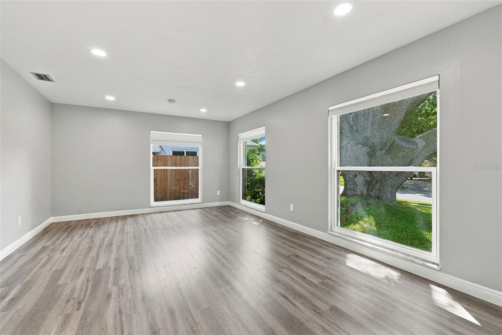 This room is across from the kitchen and enjoys views of the front yard and majestic oak tree.