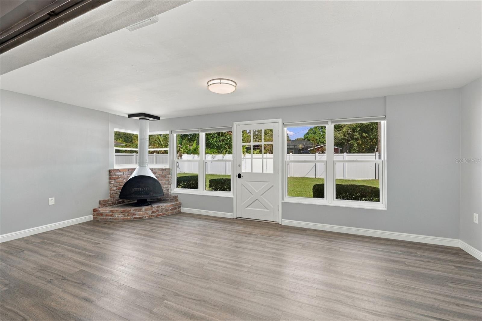Enjoy tons of natural light and views into your private backyard along with a working fireplace.