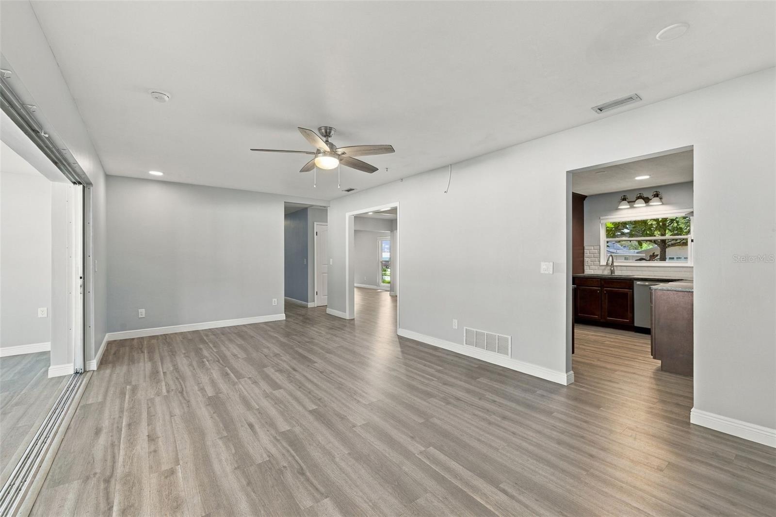 The hall on the far side leads to two additional bedrooms that share a bathroom. The split floor plan is great for creating separation and privacy for