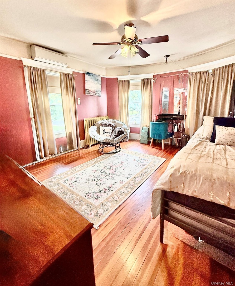 Main House Upstairs Bedroom  Hardwood flooring, painted walls with decorative border, white trim