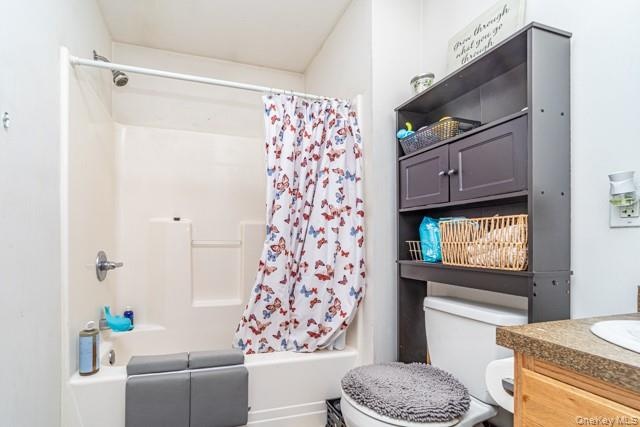 Shower/tub combination with chrome fixtures and integrated shelving