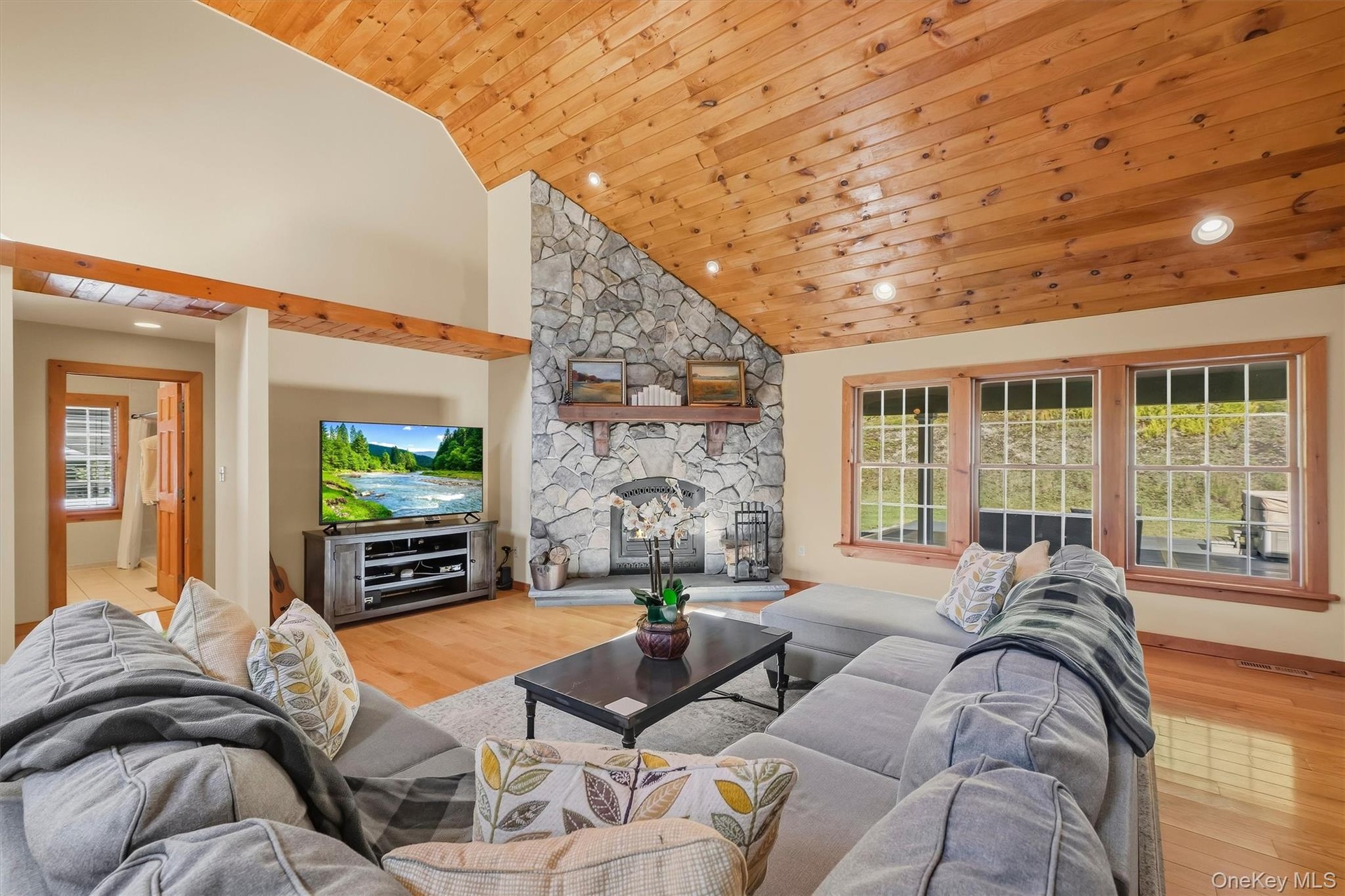 Vaulted ceiling with stone faced fireplace