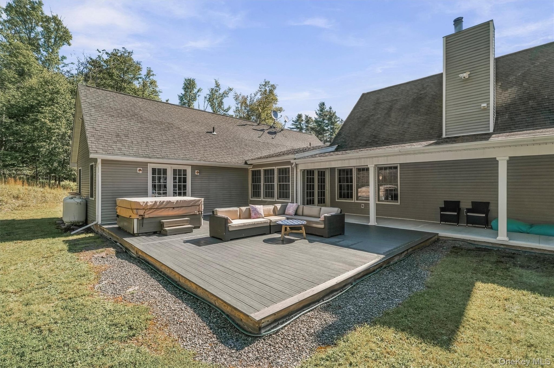 back yard deck with hot tub and lounge area