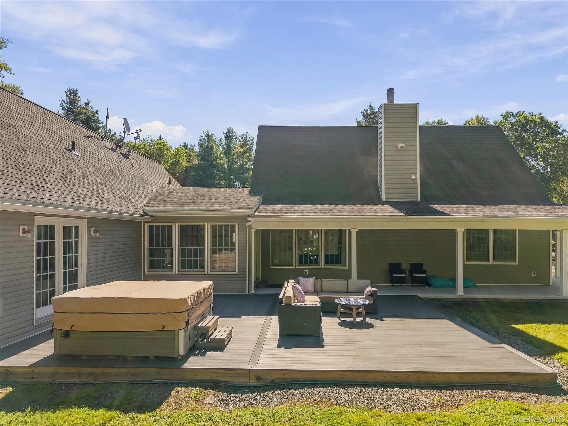 back yard deck with hot tub and lounge area