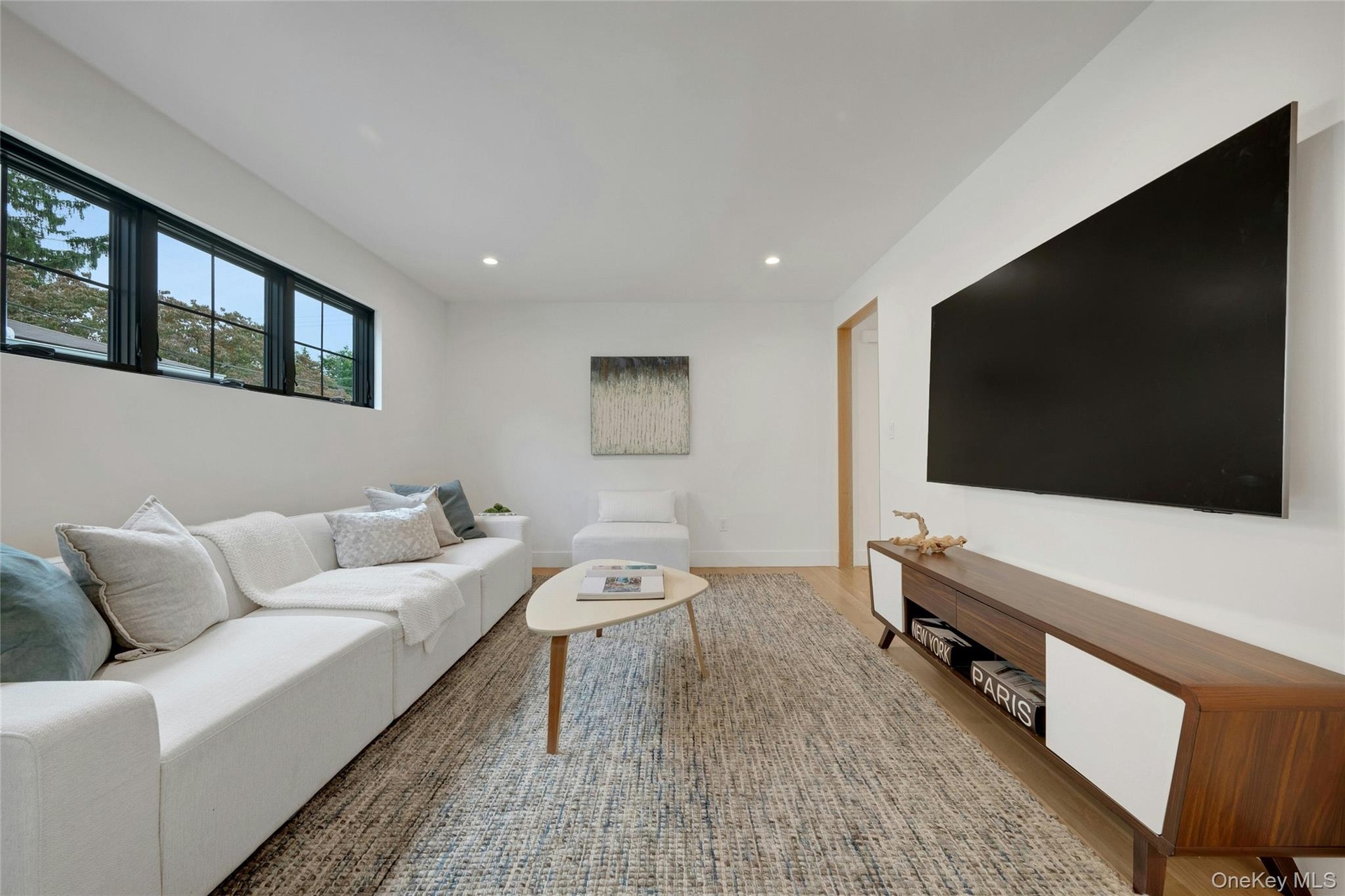 Just off the kitchen, a comfortable family room creates the perfect spot to relax, watch tv, and still feel connected to everything happening in the h