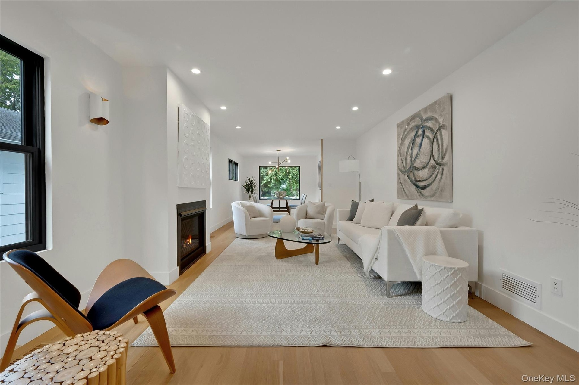 A bright and inviting living room anchored by a cozy gas fireplace.