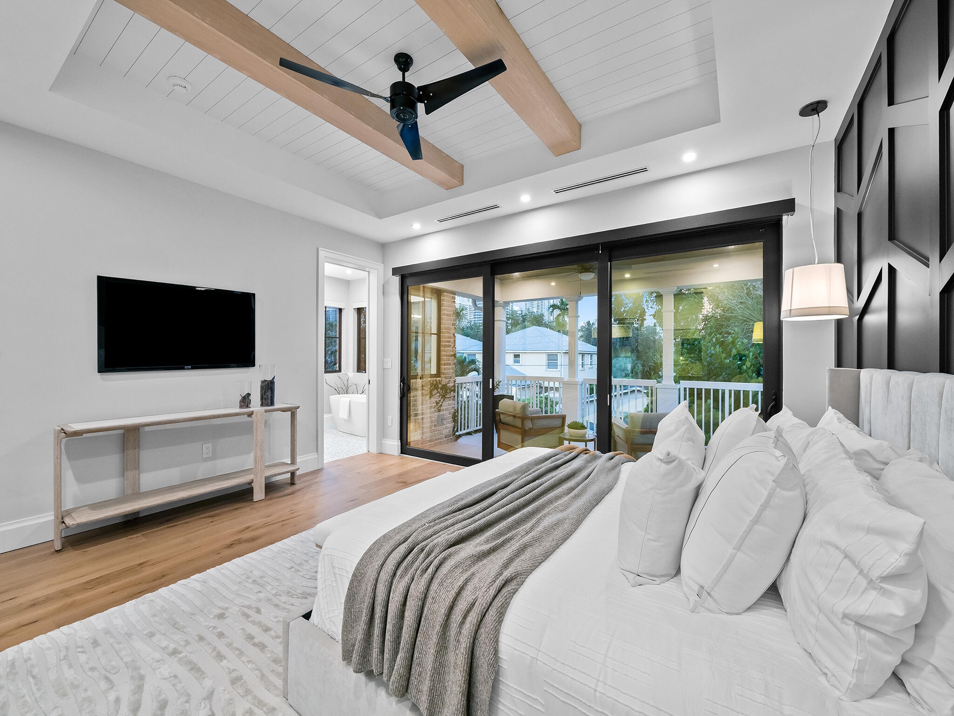 Guest bedroom with accent wall and sliding doors