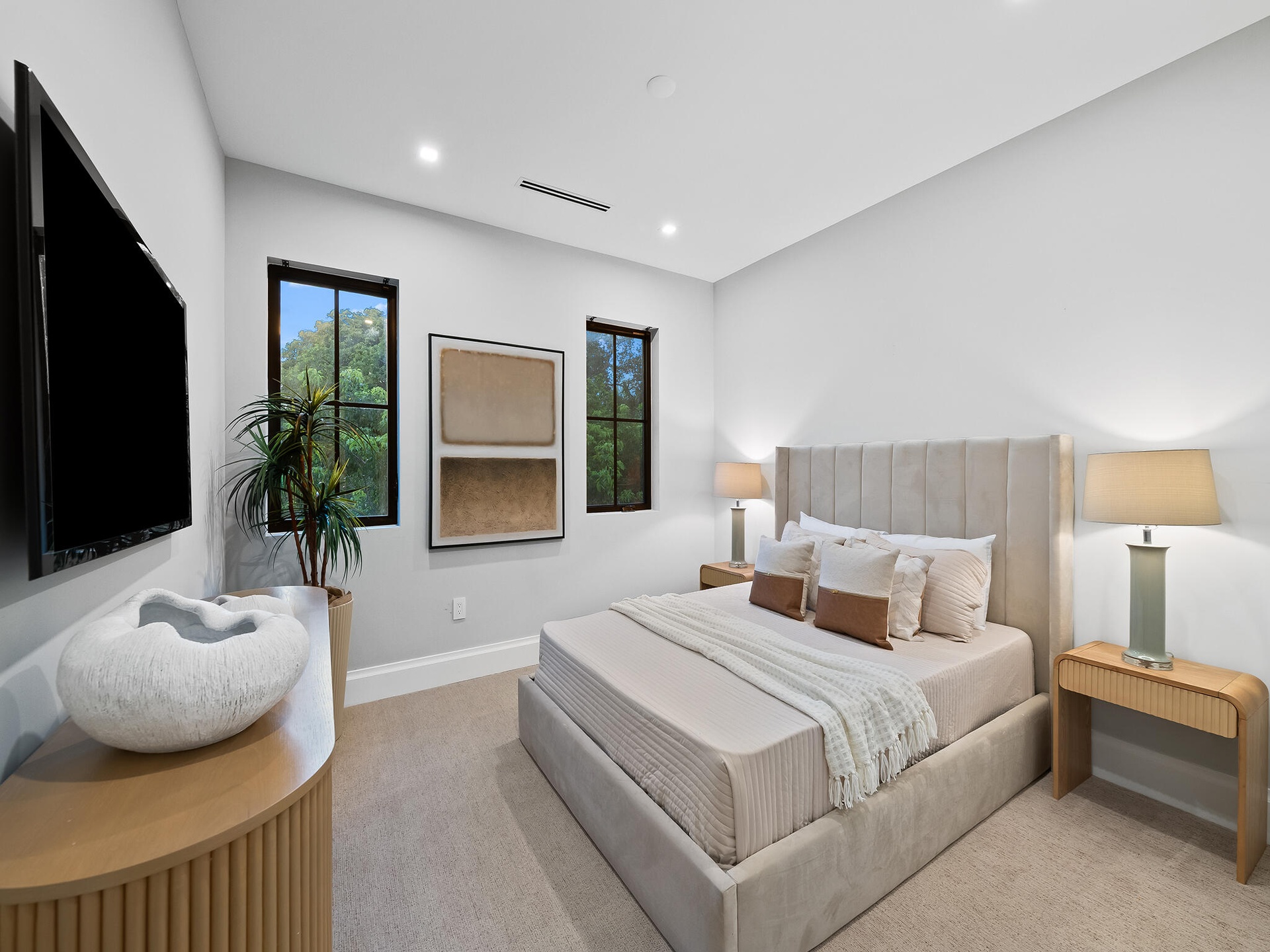 Bedroom with neutral tones and wood furniture