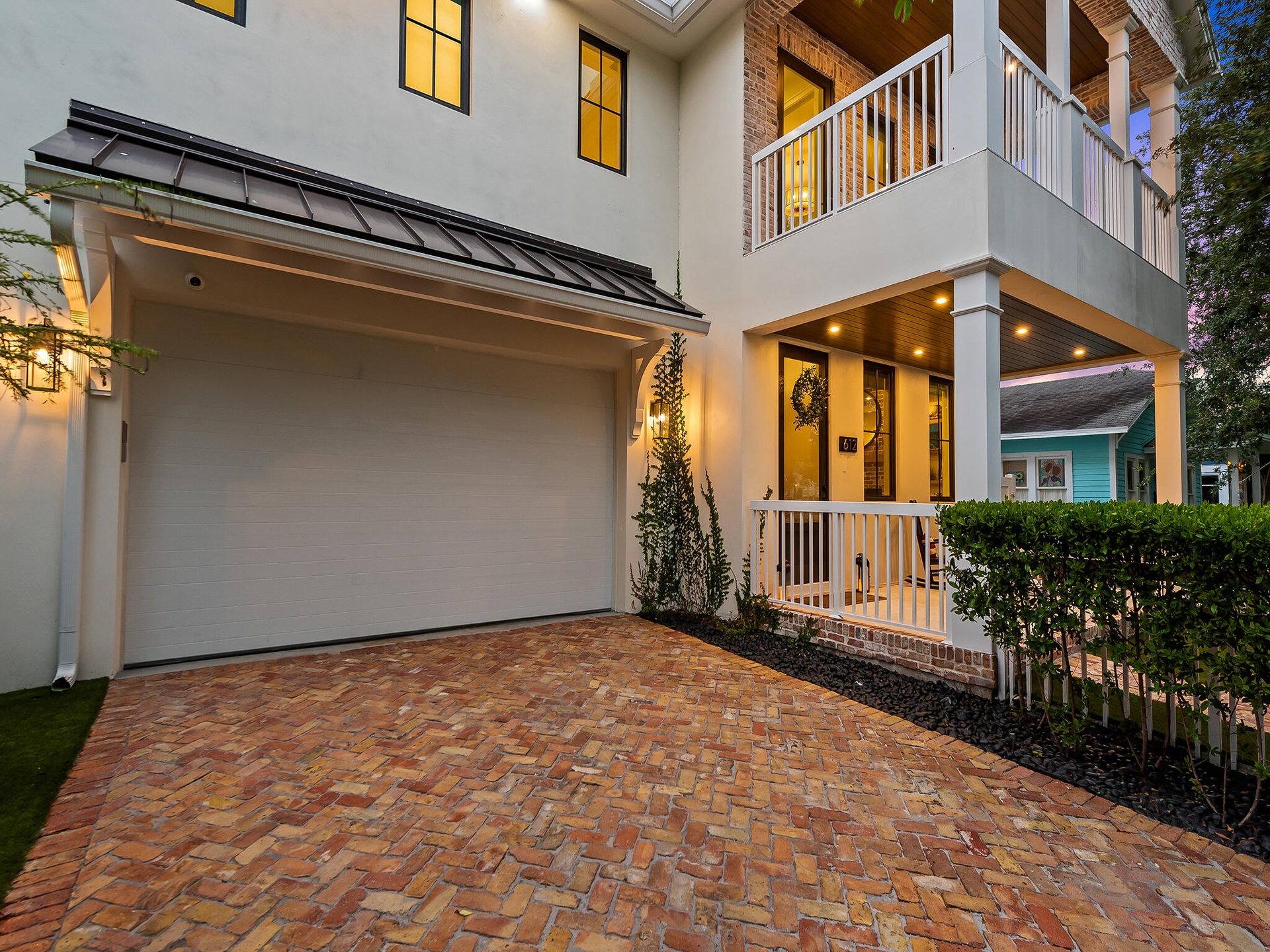 Exterior with garage and brick driveway