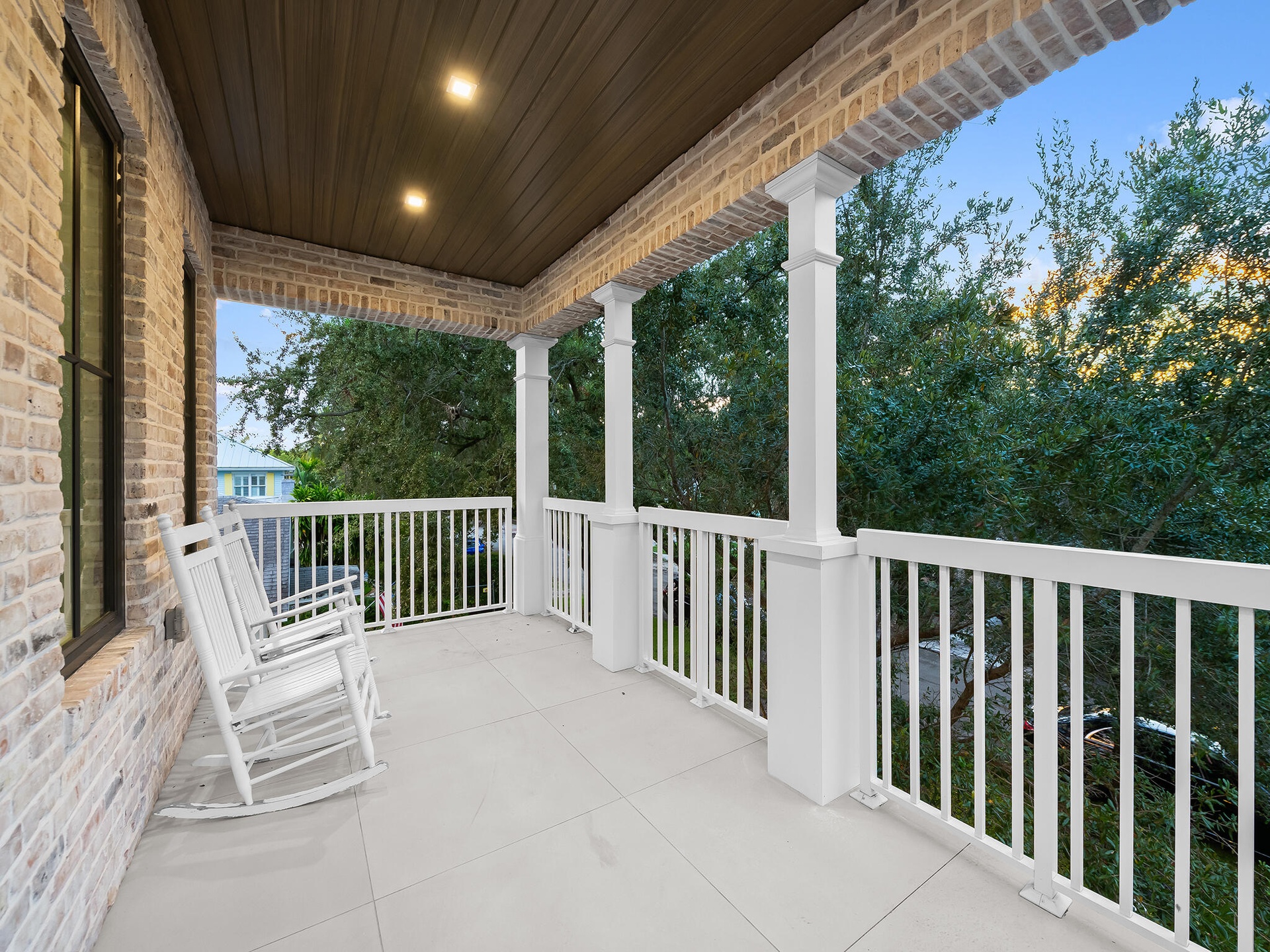 Covered front porch with white railing