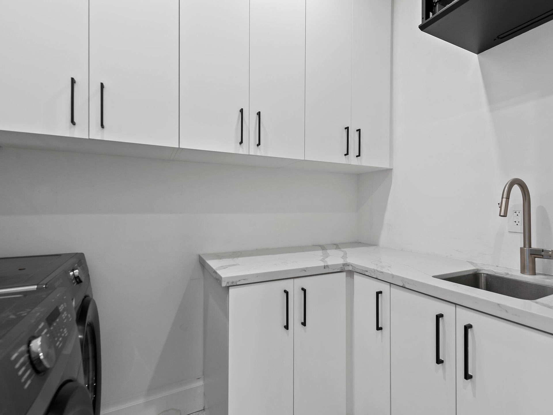 Laundry room with sink and cabinetry