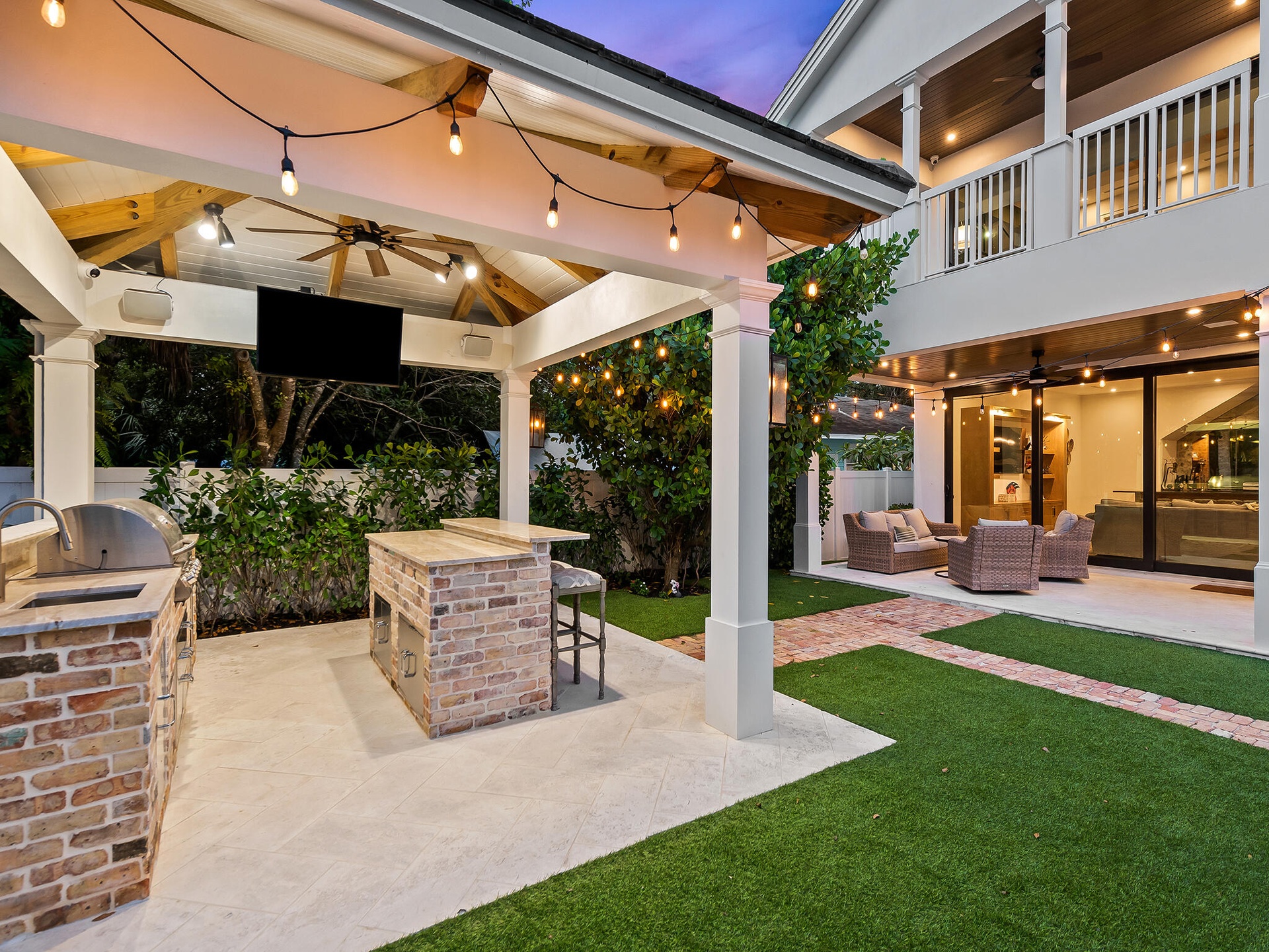 Covered patio with grilling station and string lights