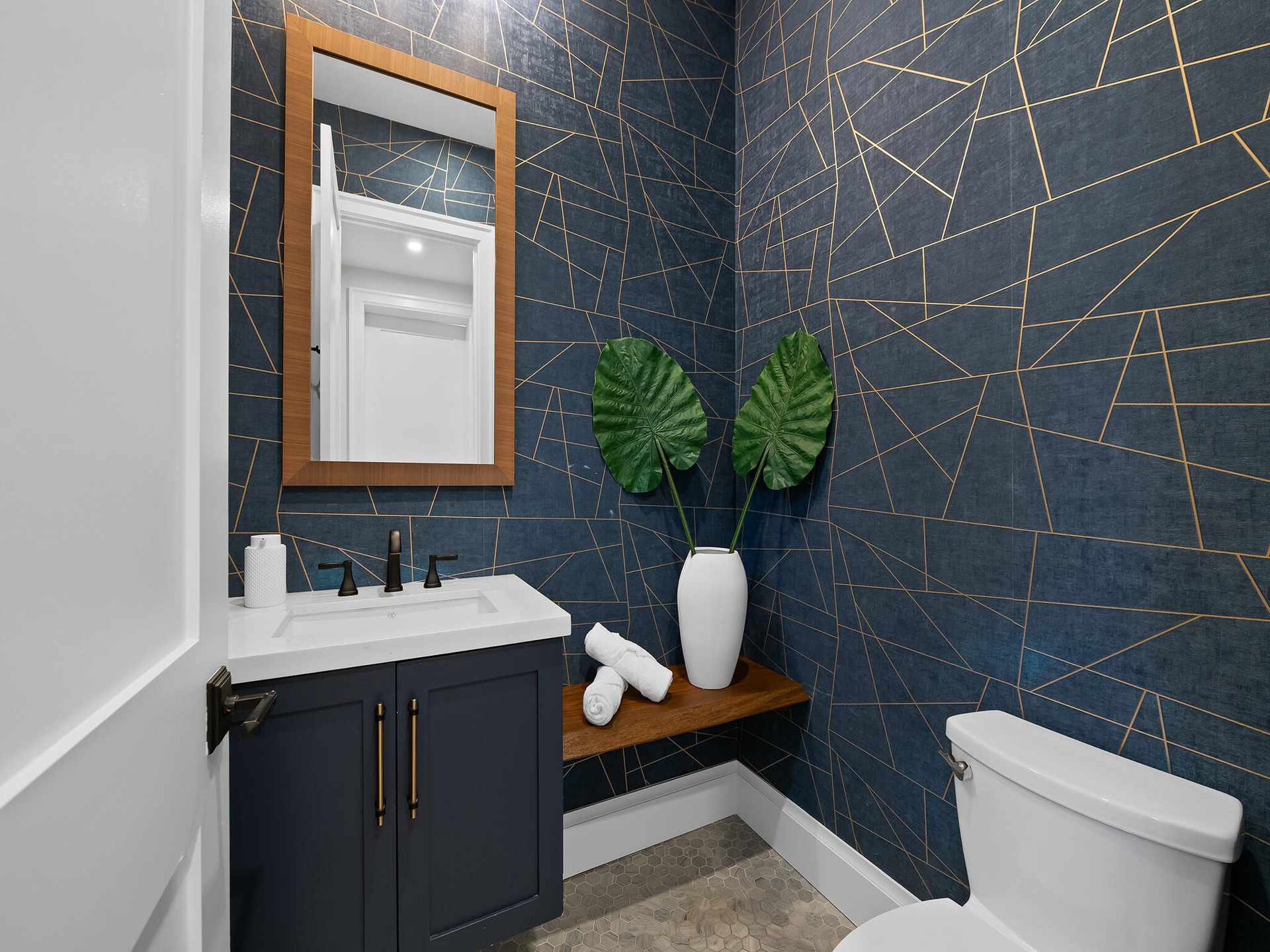 Powder room with geometric wallpaper