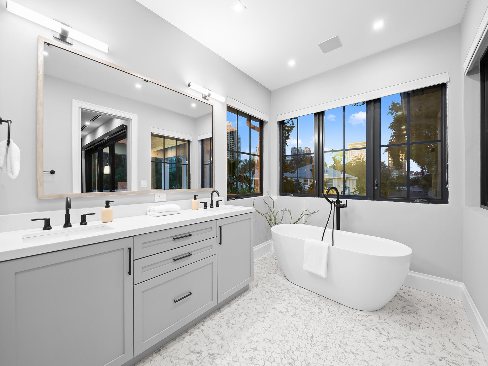 Primary bathroom with double vanity and freestanding tub