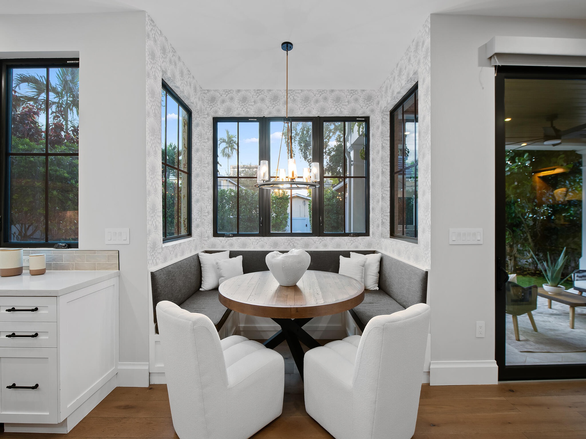 Dining nook with round table and black-framed windows