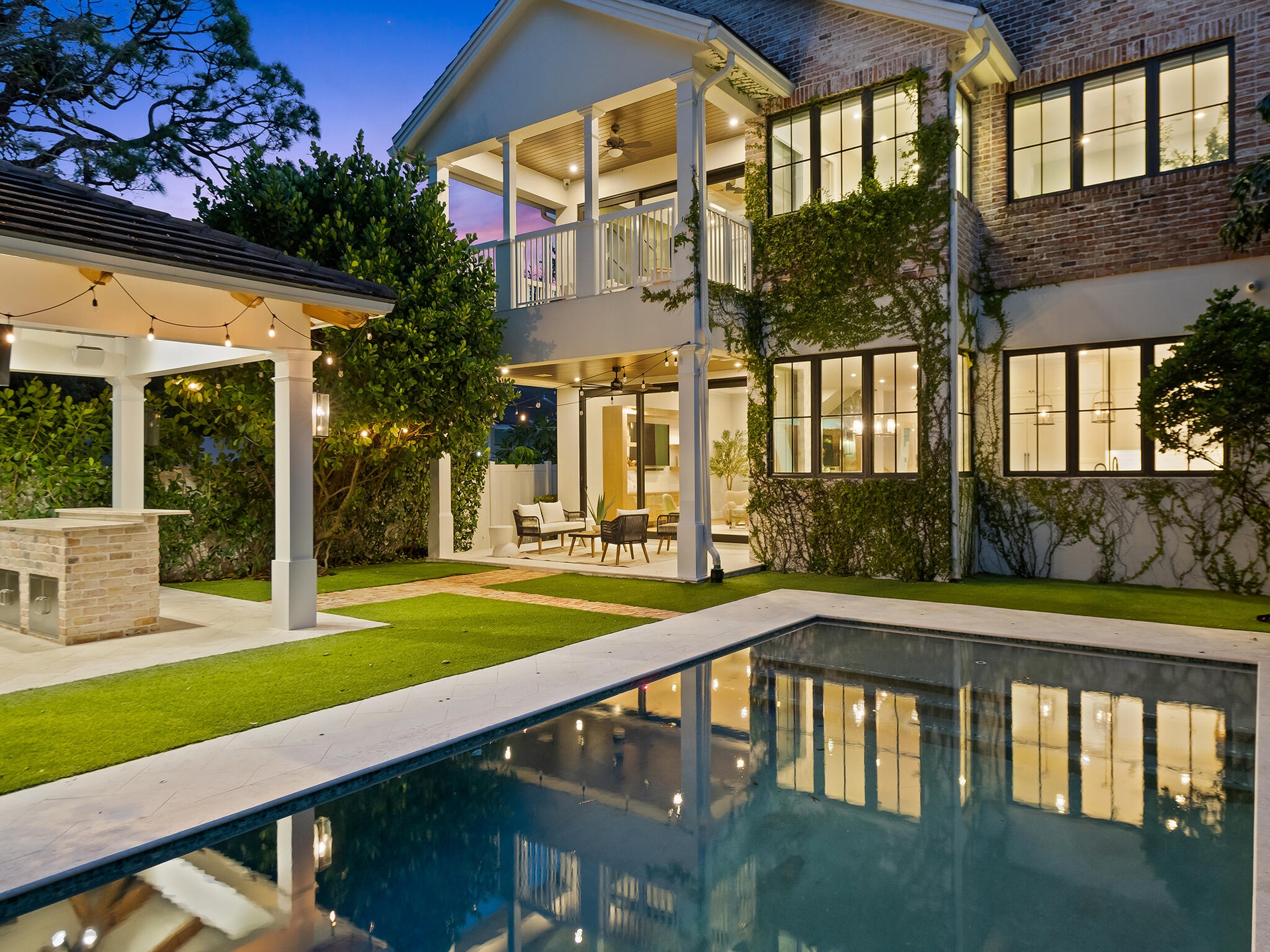 Rear exterior with pool at dusk