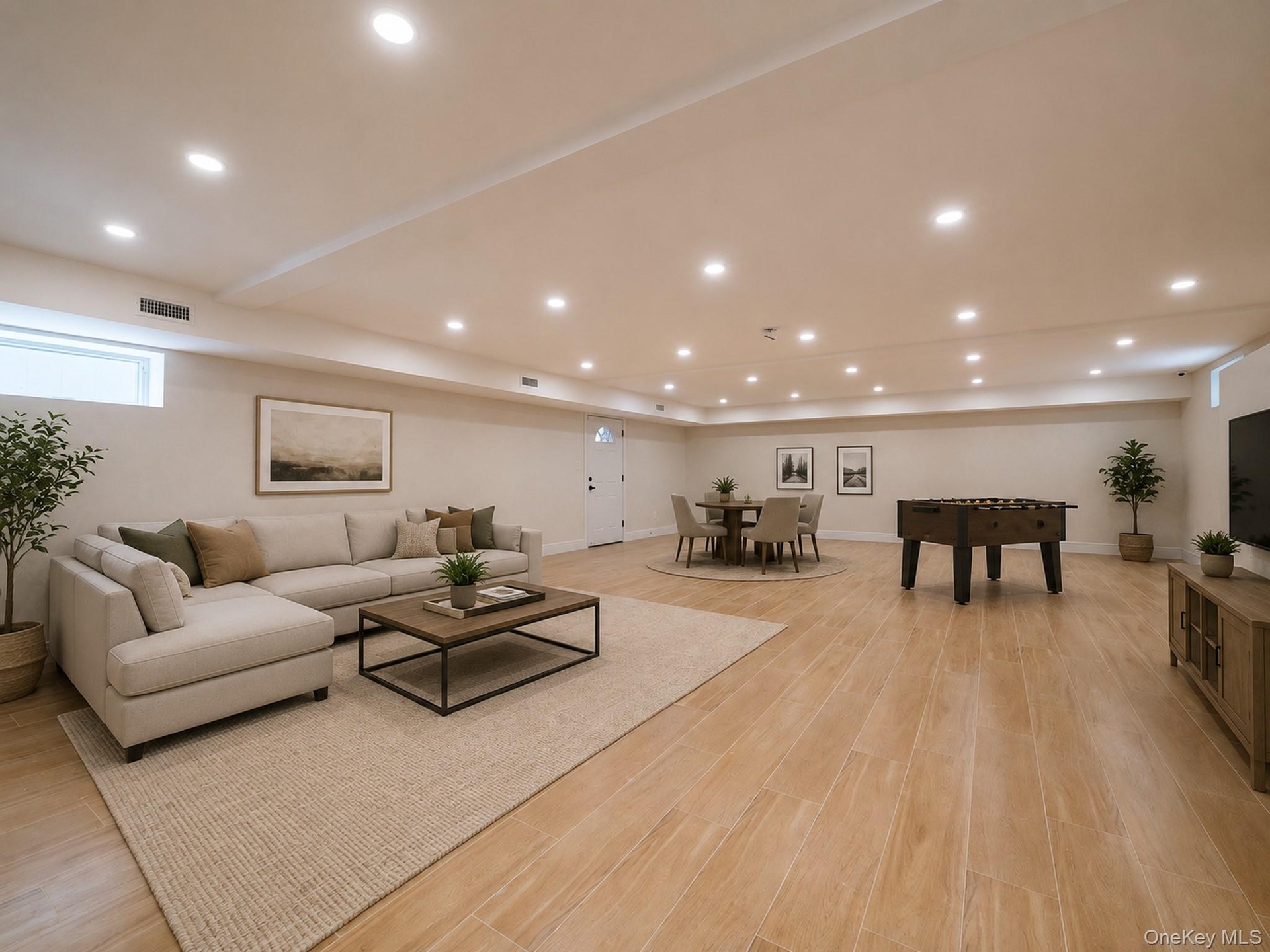Recessed lighting throughout, wood-finish flooring, light-toned walls, and a window for natural light