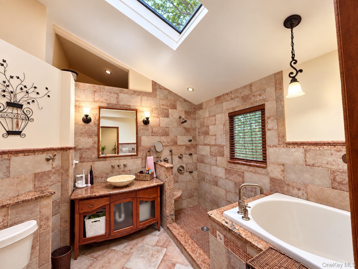 Cathedral ceilings with skylight.  Stone shower and deep soaking custom tub