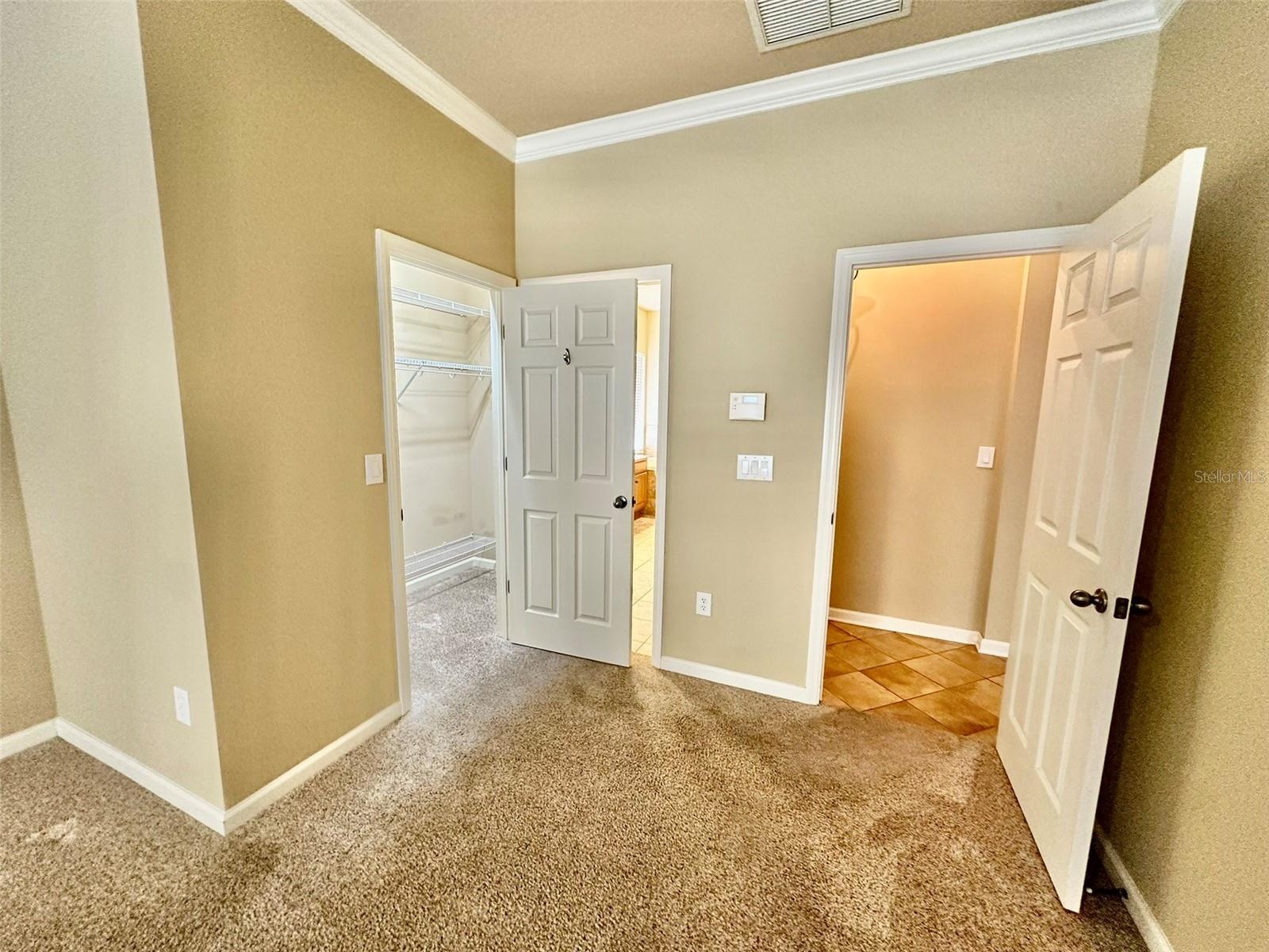 Master bedroom with 2 walk in closets