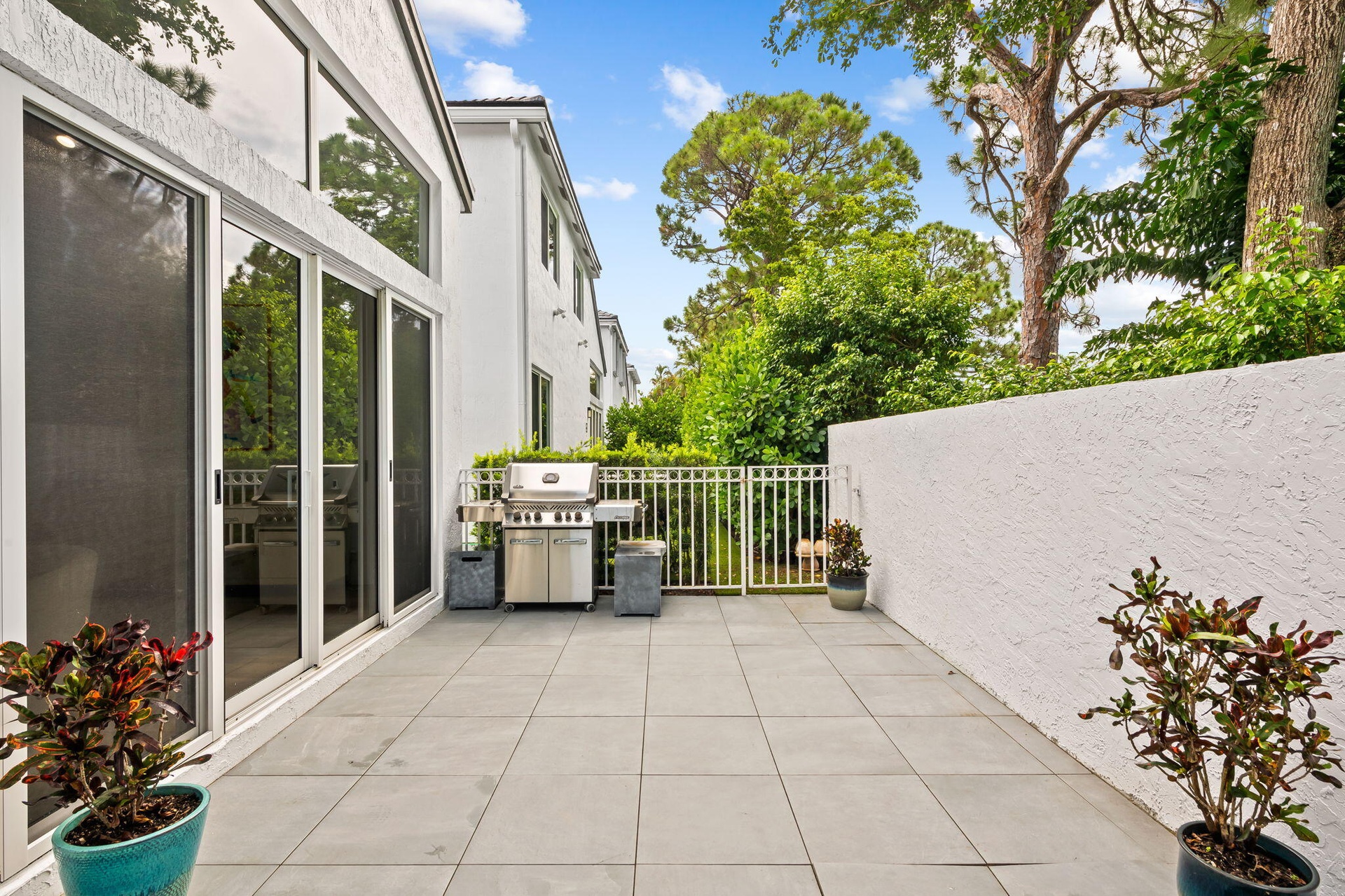 Backyard wraps all the way around to the pool