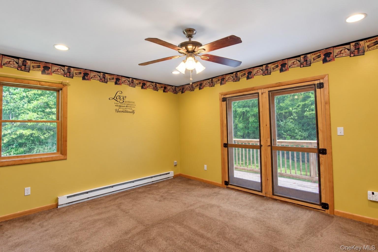 Recessed lighting, ceiling fan, wood-frame window, and glass-paneled double doors providing exterior access