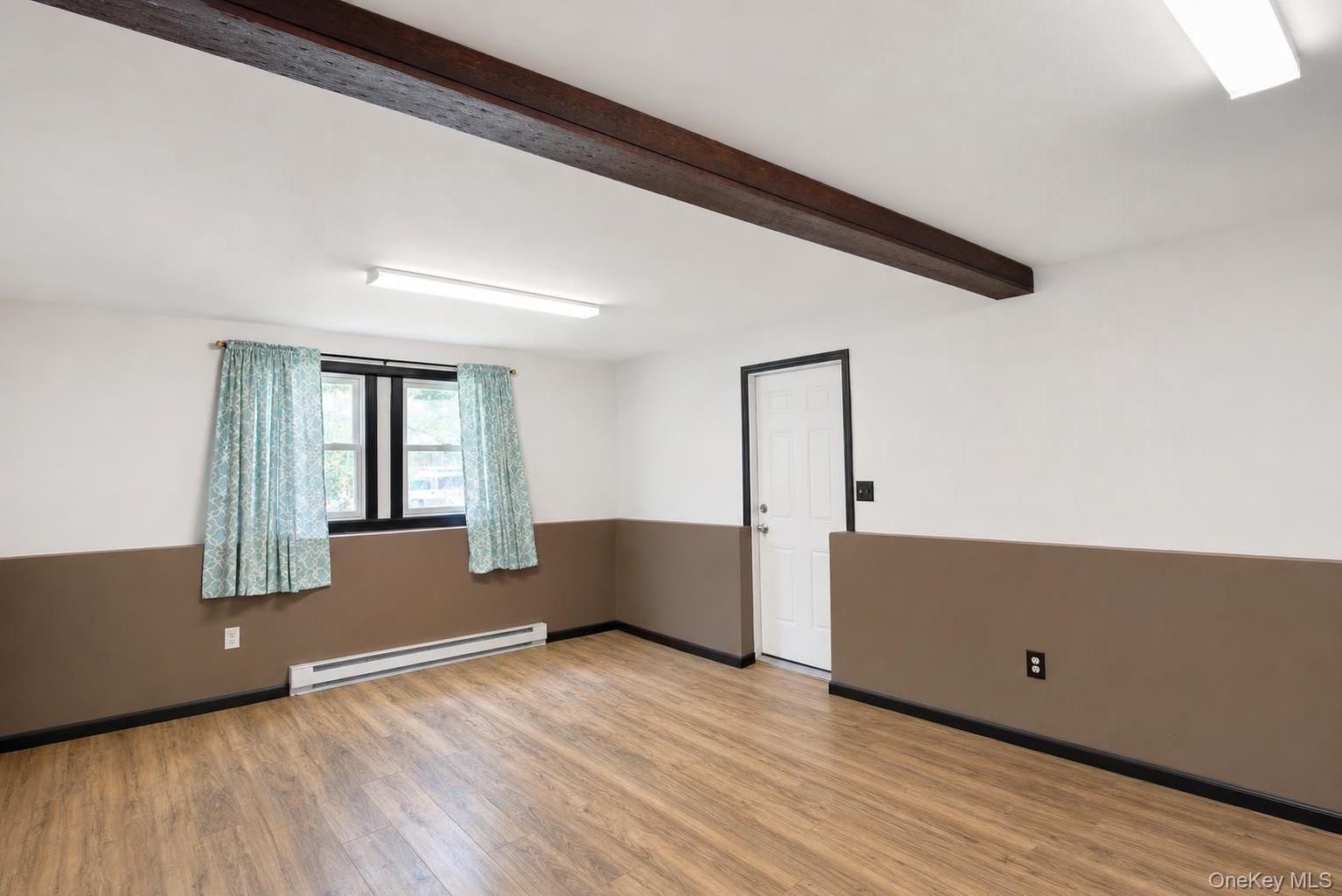 Wood-finish flooring, exposed ceiling beam and garage access